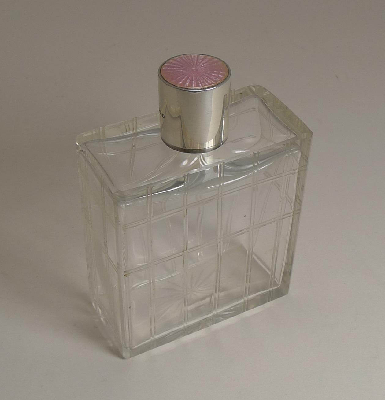 A handsome large vintage cologne or scent bottle engraved with a very modern geometric design.

The screw top is made from English sterling silver fully hallmarked for London 1948, the makers mark is also present for the top-notch silversmith,