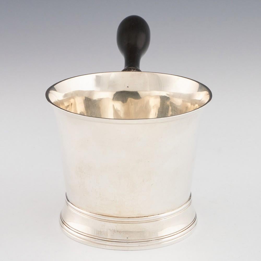 Heading : Sterling silver brandy pan by Peter and Ann Bateman
Date : Hallmarked in London 1804
Period : George III
Origin : London, England
Decoration : Reeded flared base. Turned wooden handle
Size :  Diameter 9.7 cm, pint capacity without