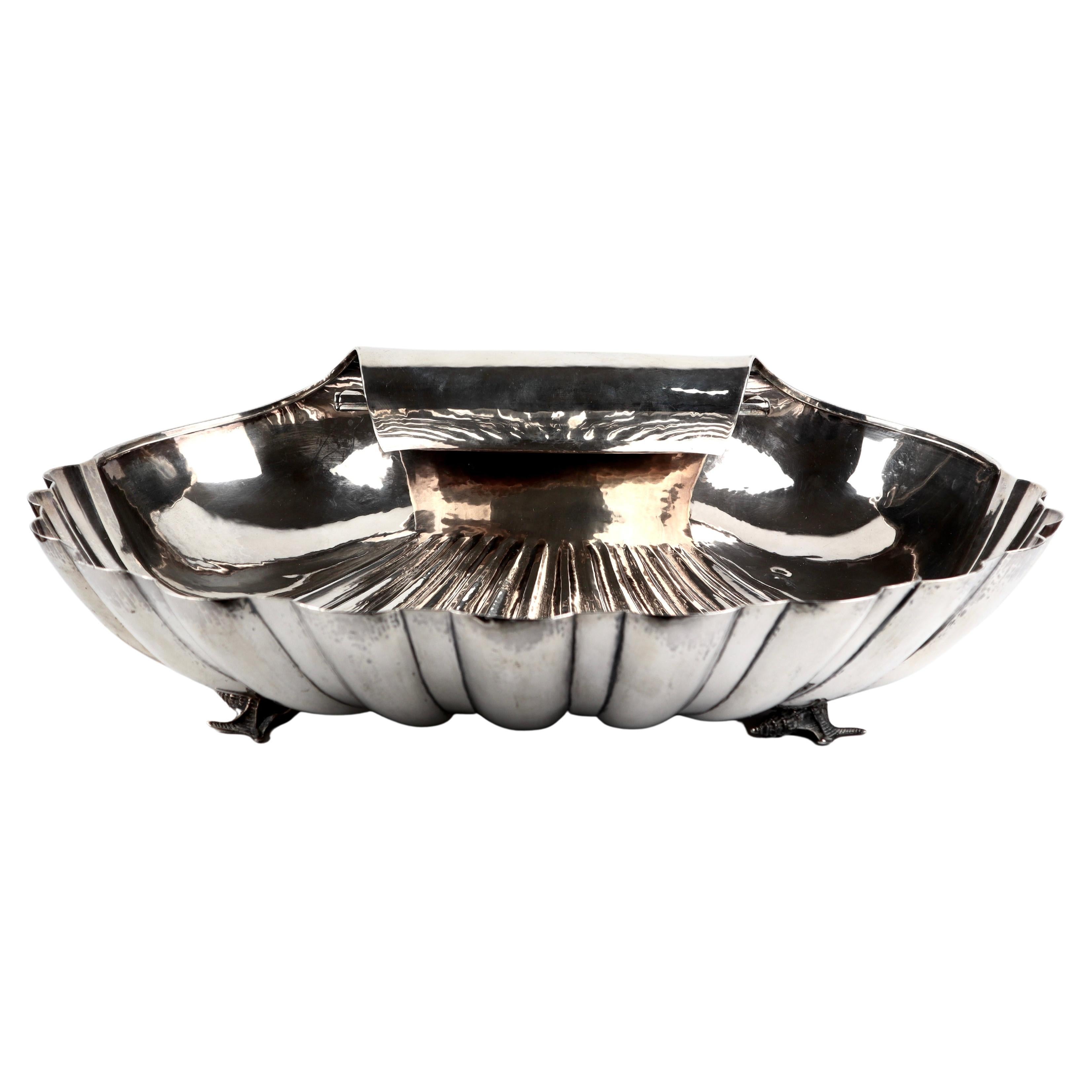 A magnificent sterling silver Scallop Shell centrepiece on a grand scale, deep fluted scalloped rim and a furled handle. the shells body rests on 4 crafted shell supports.
Hallmarked Buccellati Italy Sterling
Date Circa 1934-44
Weight 3904