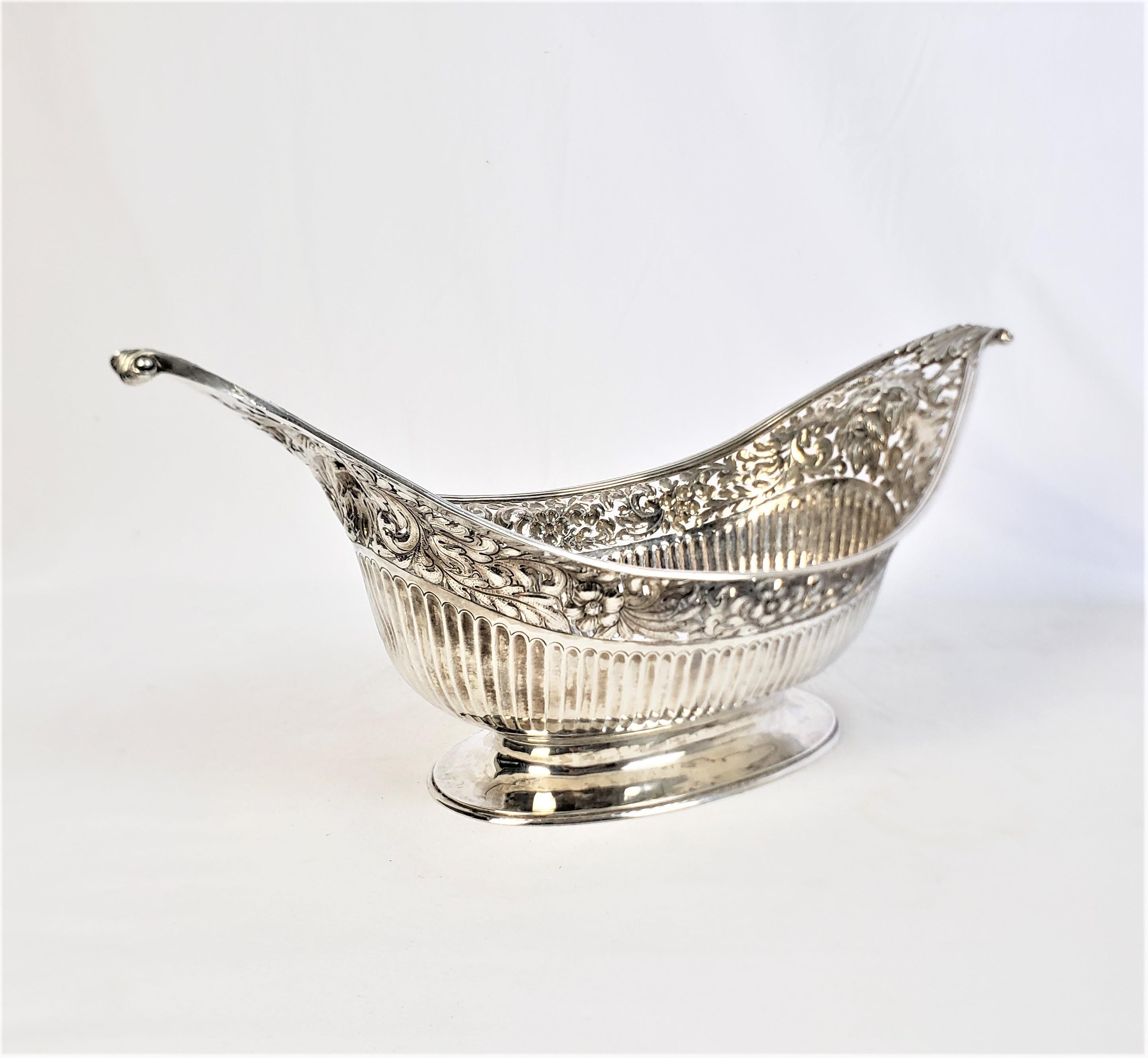 Hand-Crafted Large Sterling Silver Georgian Pierced Basket with Repousse Faces & Floral Decor For Sale