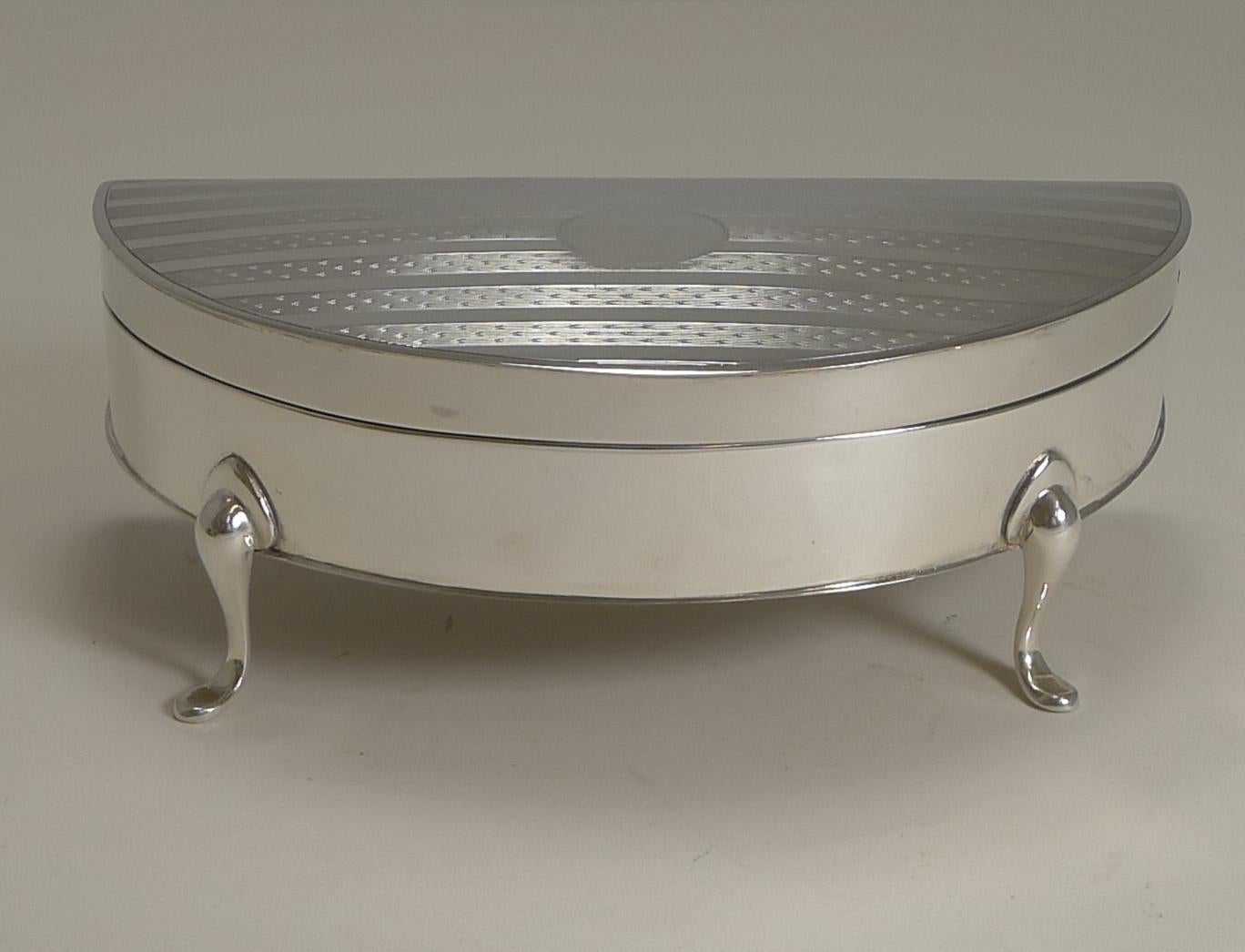 A very elegant large jewelry box, perfect for both a lady or gentleman to keep anything from Diamonds to cufflinks. The demilune form stands on form elegant cabriole legs and the lid is beautifully decorated with engine turning surrounding a central