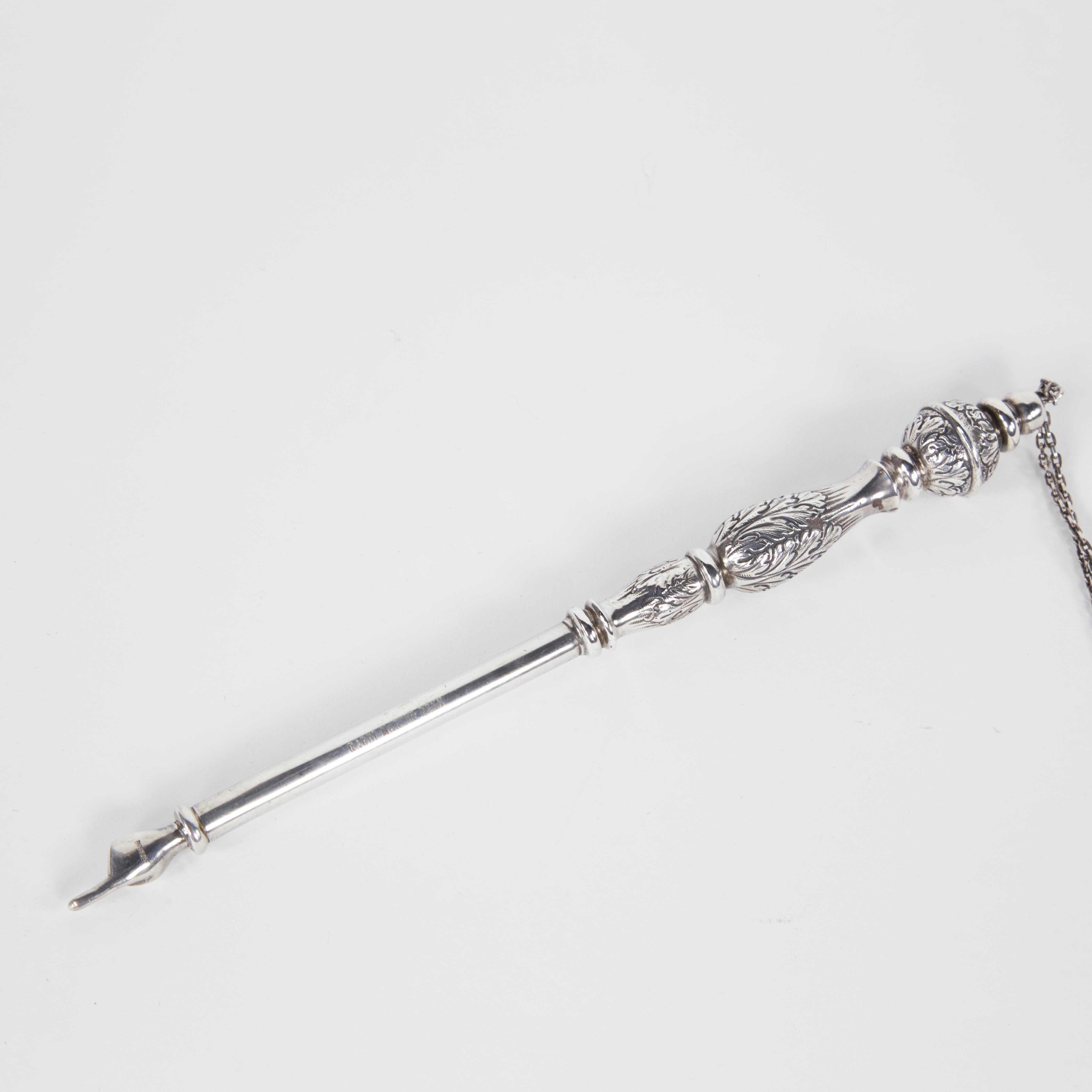 A fine and impressive Jewish Yad known as a Torah pointer handcrafted in sterling silver; bulbous knob handle decorated with embossed acanthus leave designs, with a traditional pointed finger hand on the other end. Marked: RABBI MARTIN PENN. Yad
