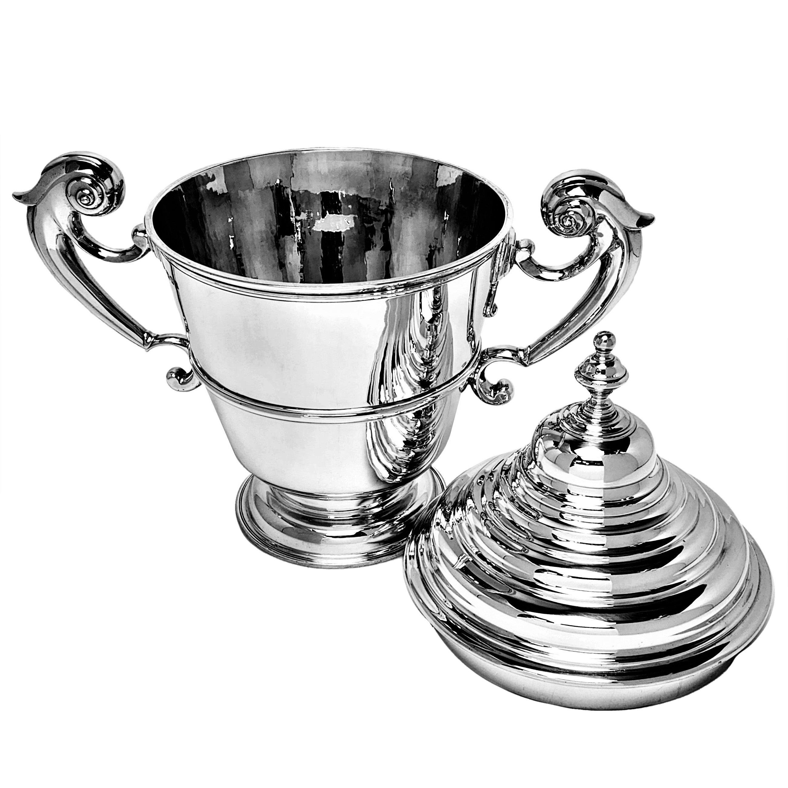 An impressive solid Silver Lidded Cup and Cover with two substantial silver scroll handles and a tall domed lid. The Trophy has a polished exterior and is suitable for engraving if desired. This Two Handled Cup is perfect as an impressive prize or