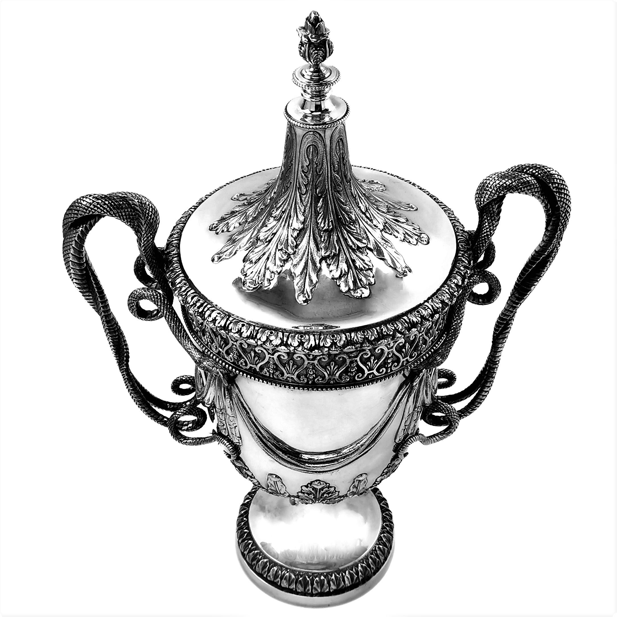 A magnificent solid Silver Cup with a monumental push fit lid. The Trophy is created in the Regency style with inspiration from the designs of Paul Storr. The Trophy has a pair of impressive handles each in the shape of two snakes twisted around