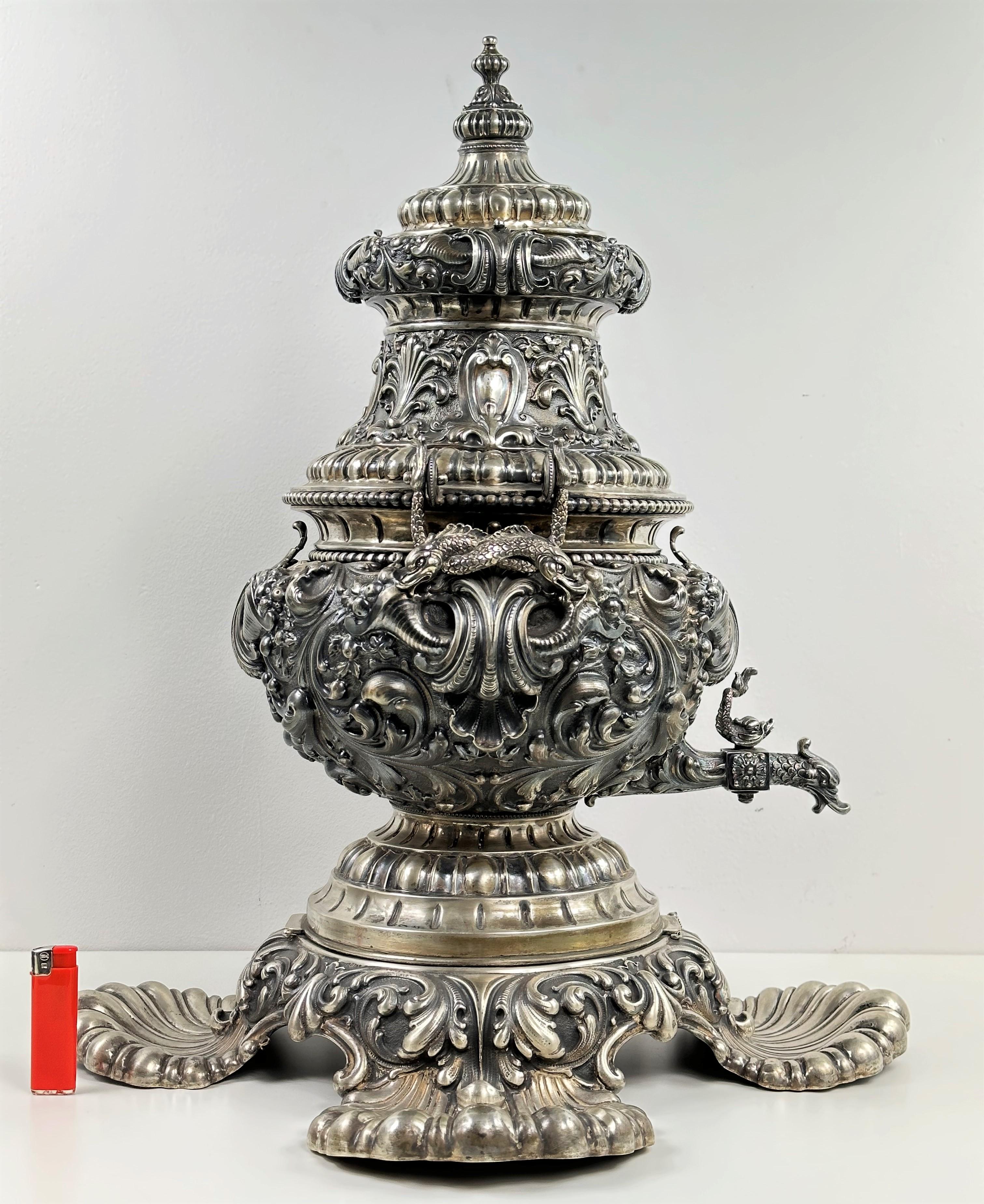 Incredible, very large .800 silver Italian samovar. Very carefully designed, high level of detail. With two dolphin-shaped handles. Weight 6.5 kg

Dimensions:
height - 62 cm
base width - 52 cm
samovar width - 32 cm.