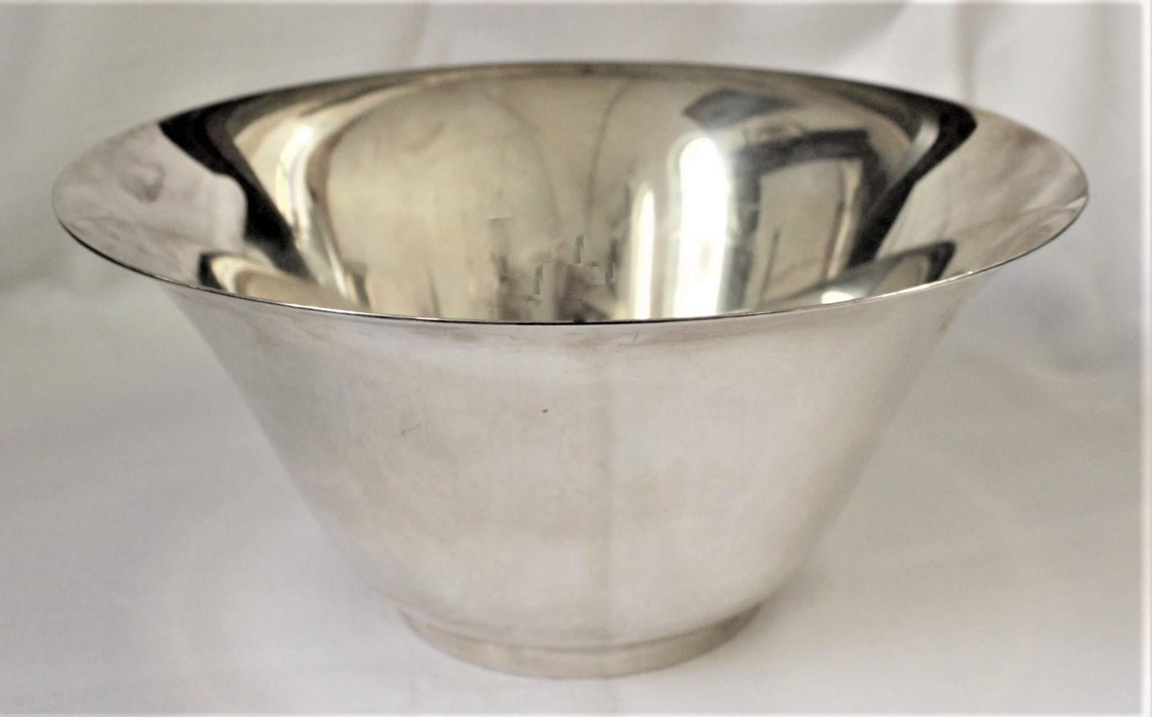 This sterling silver bowl was made for Tiffany & Co. in the United States in circa 1930 in a Modernist style. This is a large and considerably heavy example for this style of bowl done by Tiffany and has sleek flared sides and rim and a squat footed