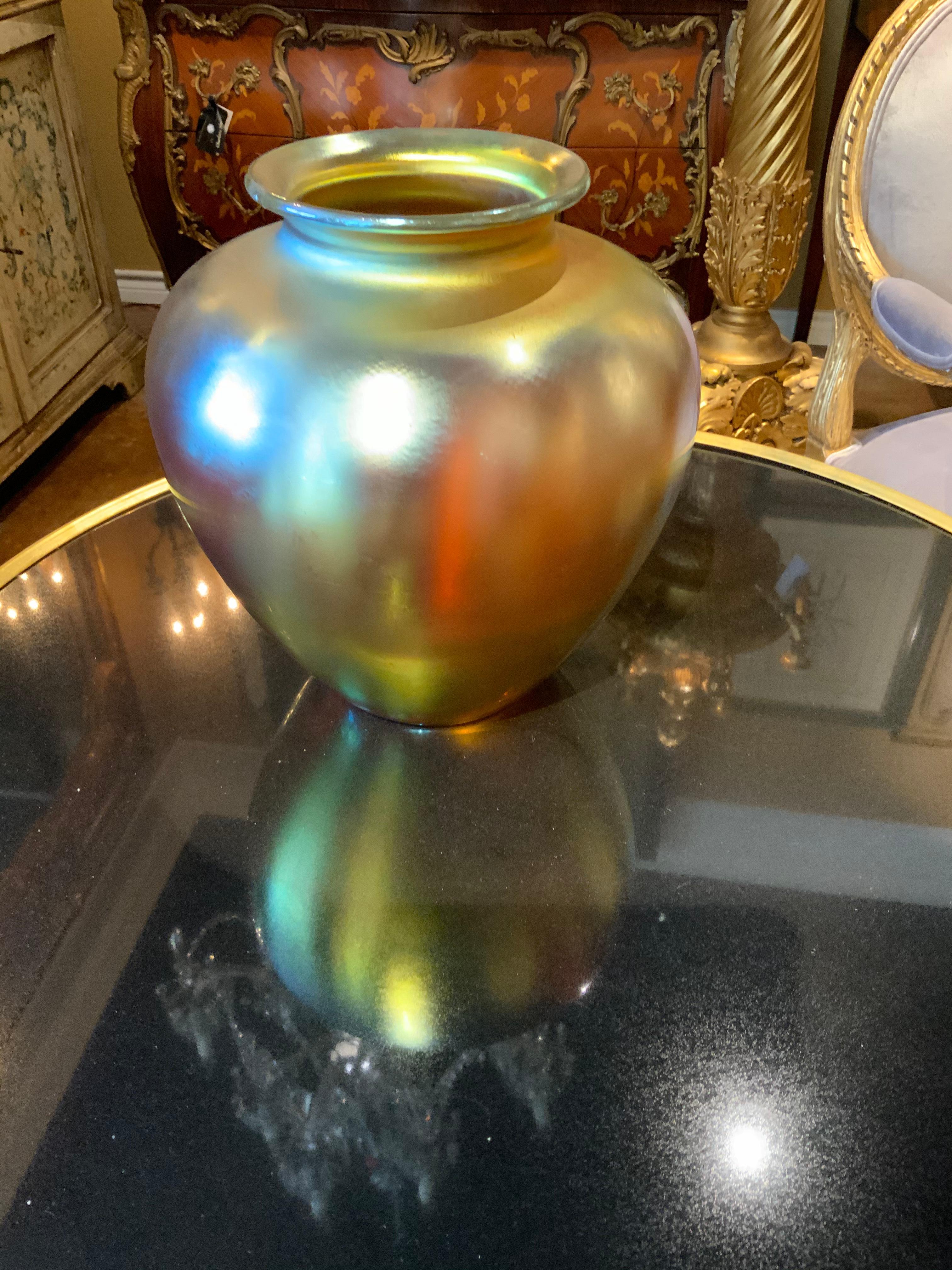 Large iridescent vase by renowned art glass maker F. Carder in shades of
Gold Aurene, baluster shape with acid etched signature on the base in
An Art Nouveau style. This piece has striking beauty in an elegant shape
and exquisite color.