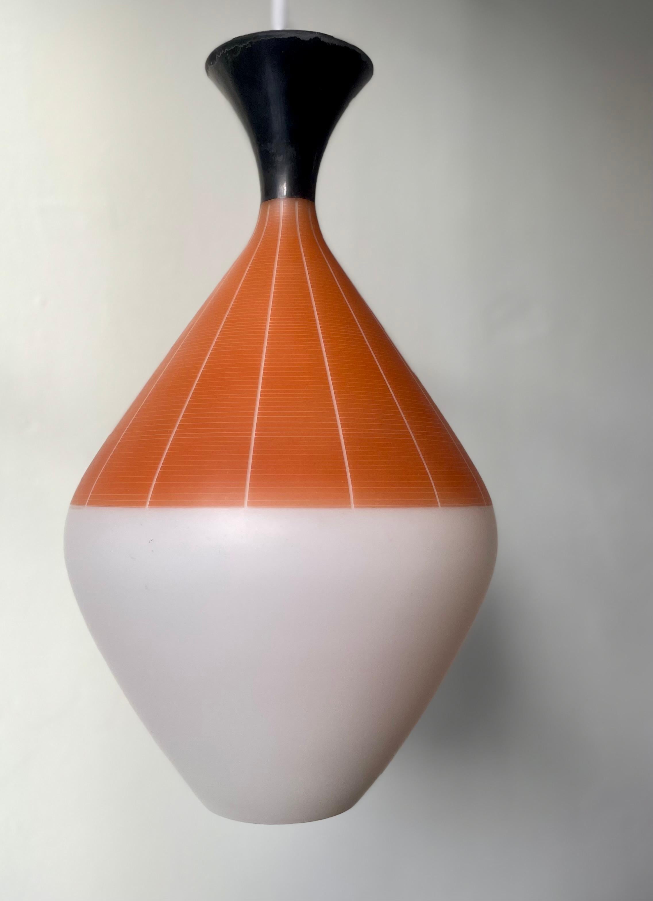 Large white opaline glass pendant with flared black top and stunning matte orange modernist decor with slender vertical lines and elegantly narrow horisontal lines. Manufactured in Italy in the 1950s attributed to Stilnovo. Beautiful vintage