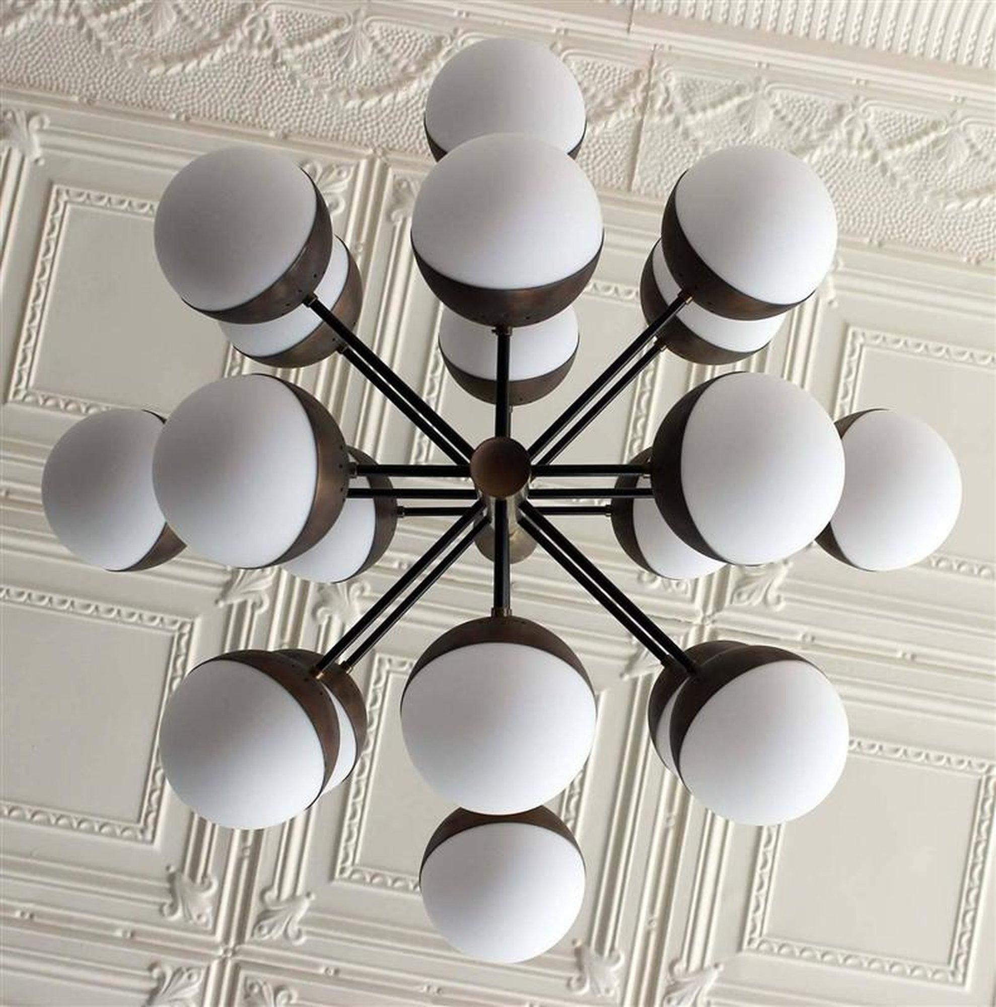 A magnificent bronzed metal 20 globe Stilnovo chandelier with milk glass Globes. Totally restored with the original Stilnovo sticker