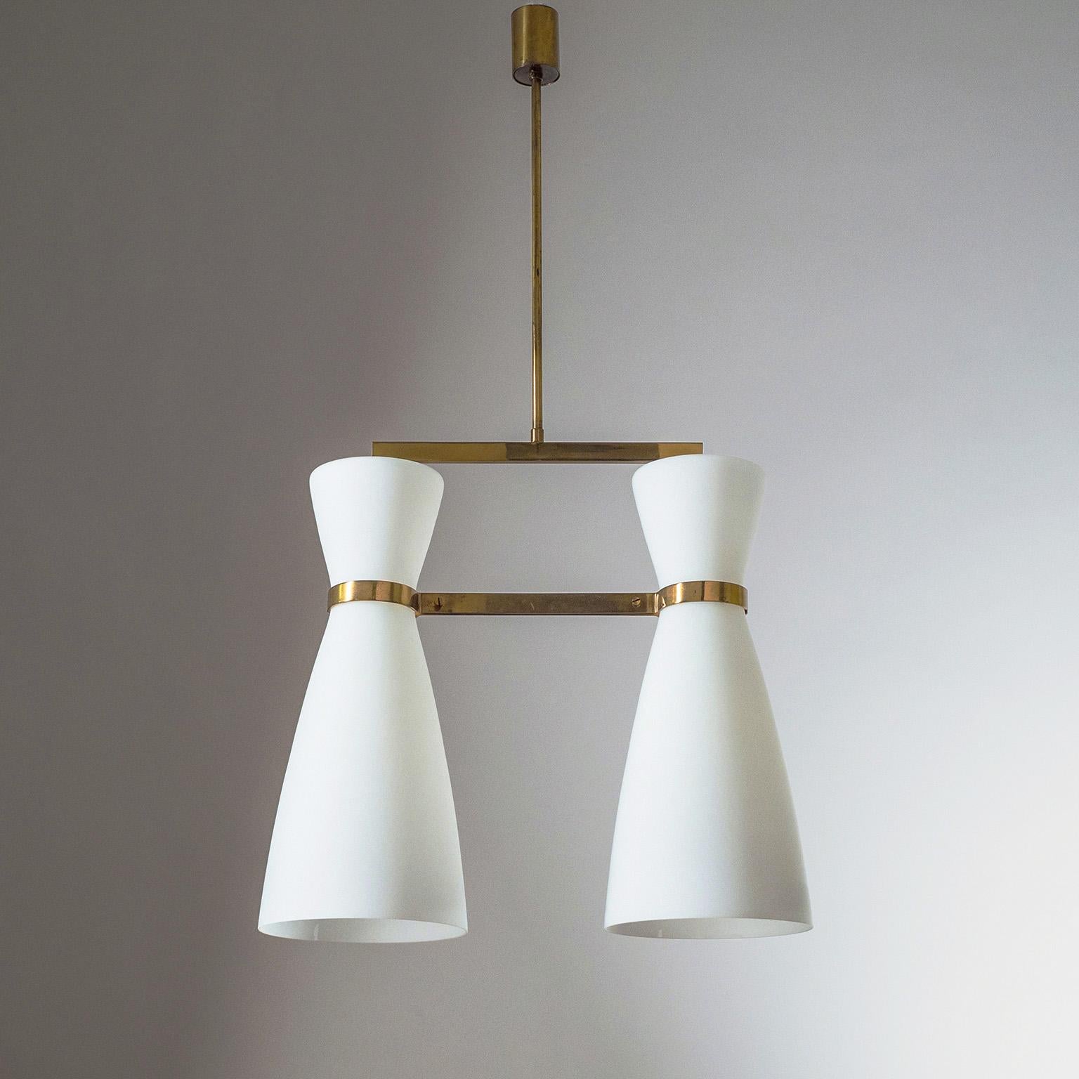 Rare modernist chandelier by Stilnovo from 1950s. Two very large (45cm/18″) tapered satin glass diffusers are suspended by a minimal polished brass structure. Original brass and ceramic E27 socket with new wiring. Original manufacturer’s label.