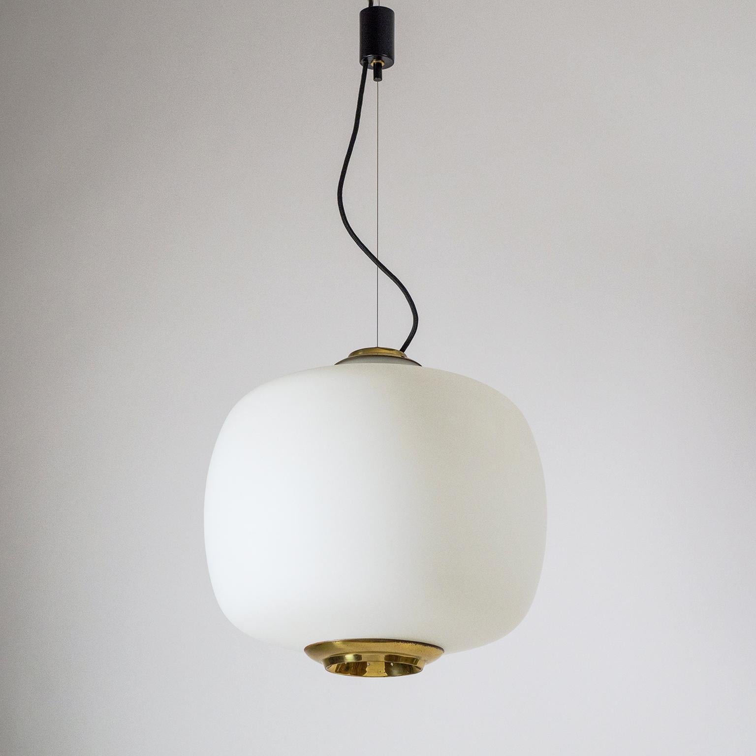 Very large and volumous satin glass and brass pendant chandelier attributed to Stilnovo, early 1960s. Beautifully shaped large blown 'triplex opal' glass body with a satin finish; sculpted and pierced brass covers on top and bottom. Suspended by a