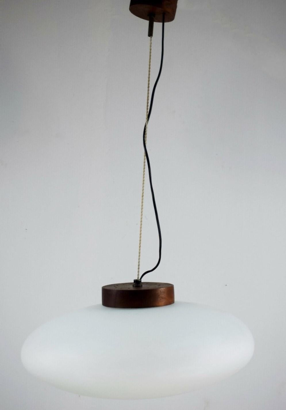 Pendant by Stilnovo manufactured in Italy, 1950s. With large brushed satin glass diffuser, teak wood mounts. It takes one E27 100w bulb. This rare and high quality pendant is in fine vintage condition, no ships or cracks, in fully working condition