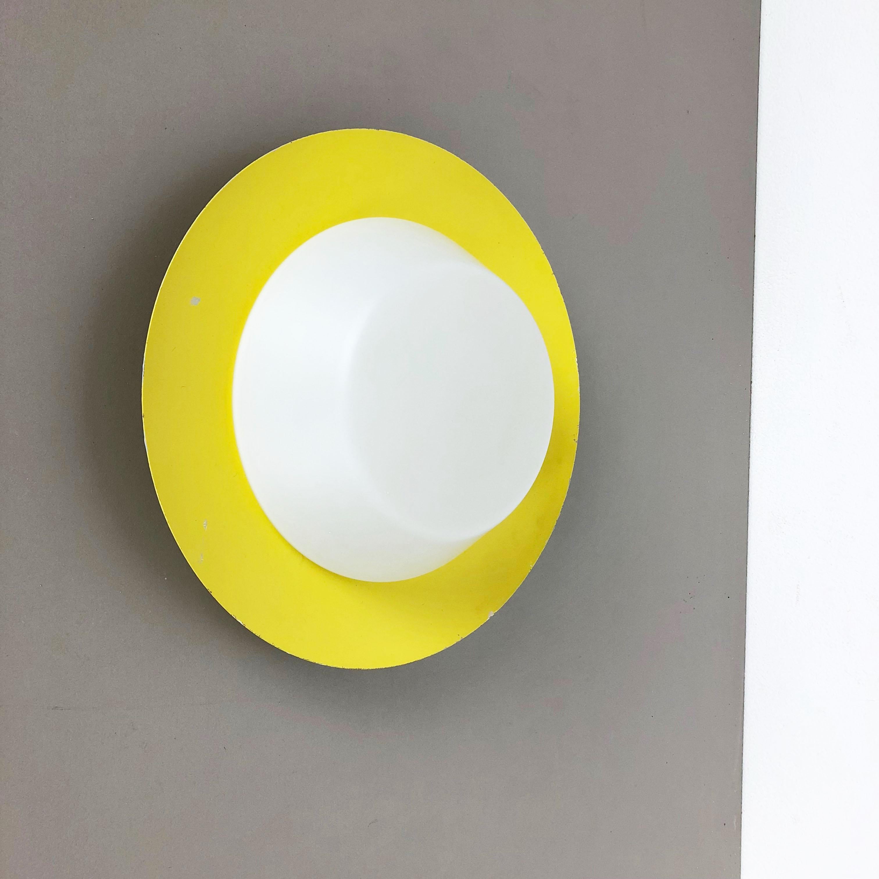 Article:

Wall lights sconces with opal glass shades.



Origin:

Italy



Age:

1960s





Original 1960s modernist Italian wall lights made of solid metal in original yellow lacquer tone and opal glass elements in the middle.
