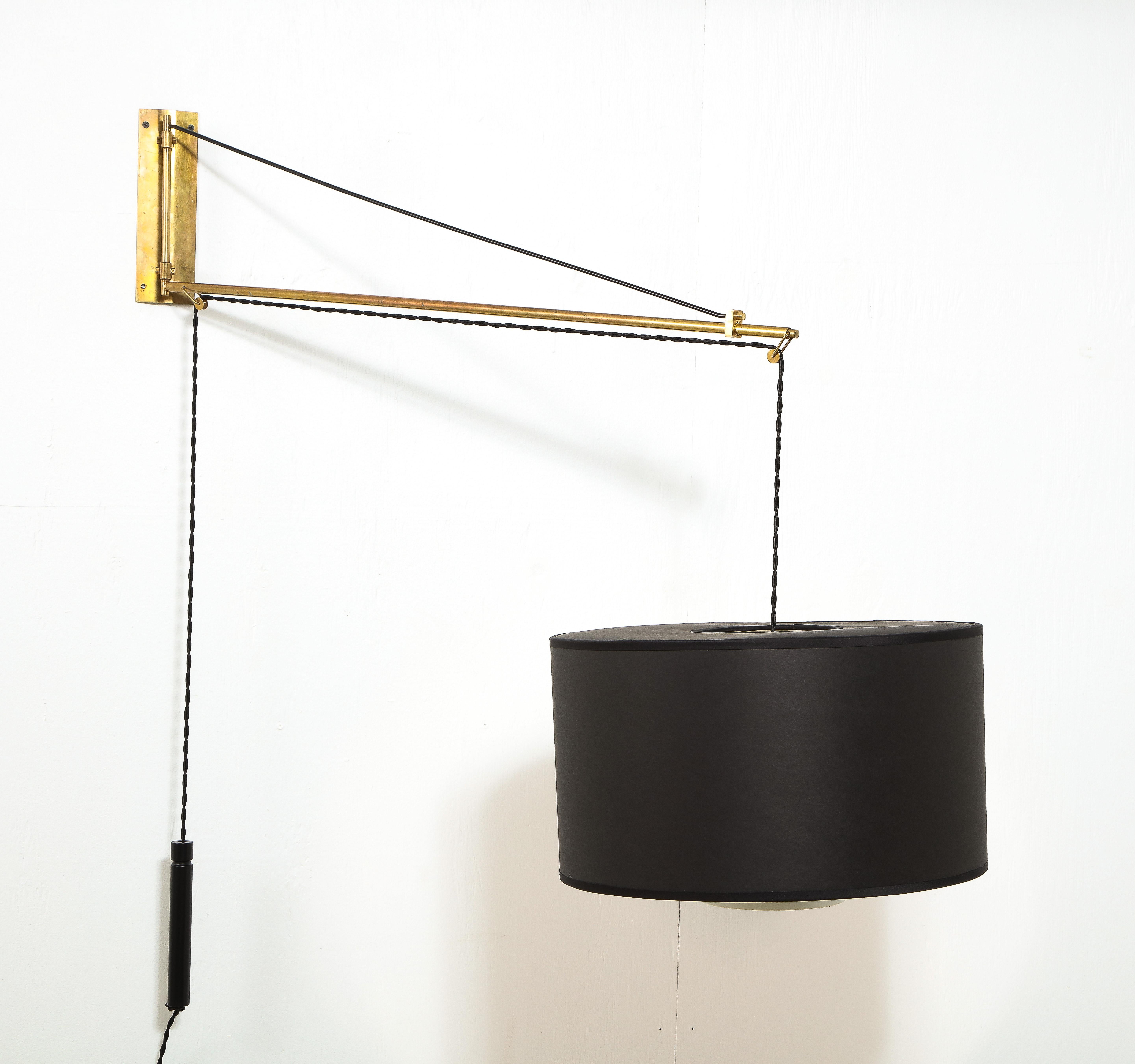A large adjustable wall sconce by Stilnovo extends to 50'' and swings from side to side, while the shade is adjustable up and down with a counterweight. Can we wired for plug-in or hardwired applications. 