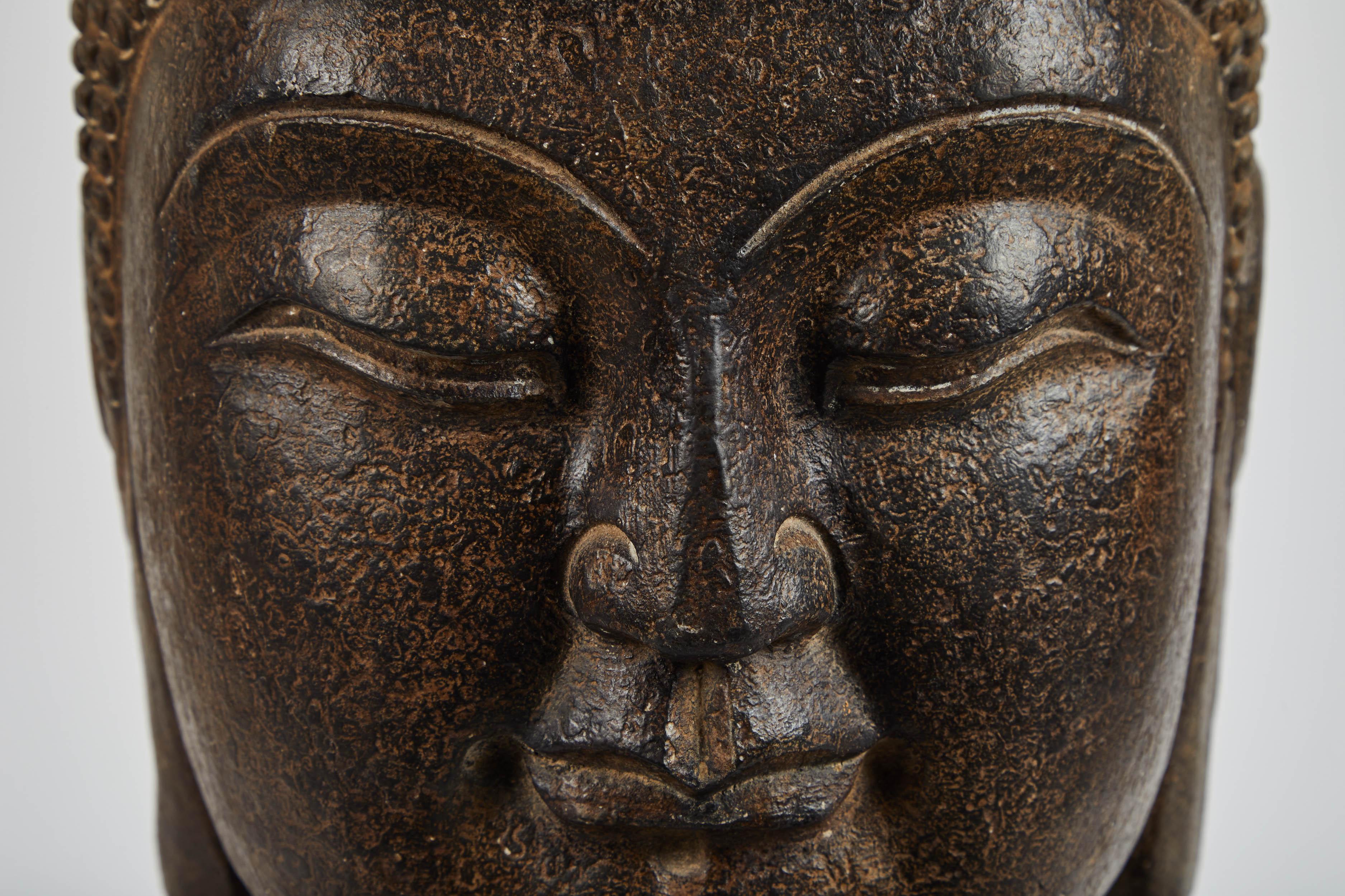A large buddha head carved from stone. From Hebei, China. Is contemporary in design.