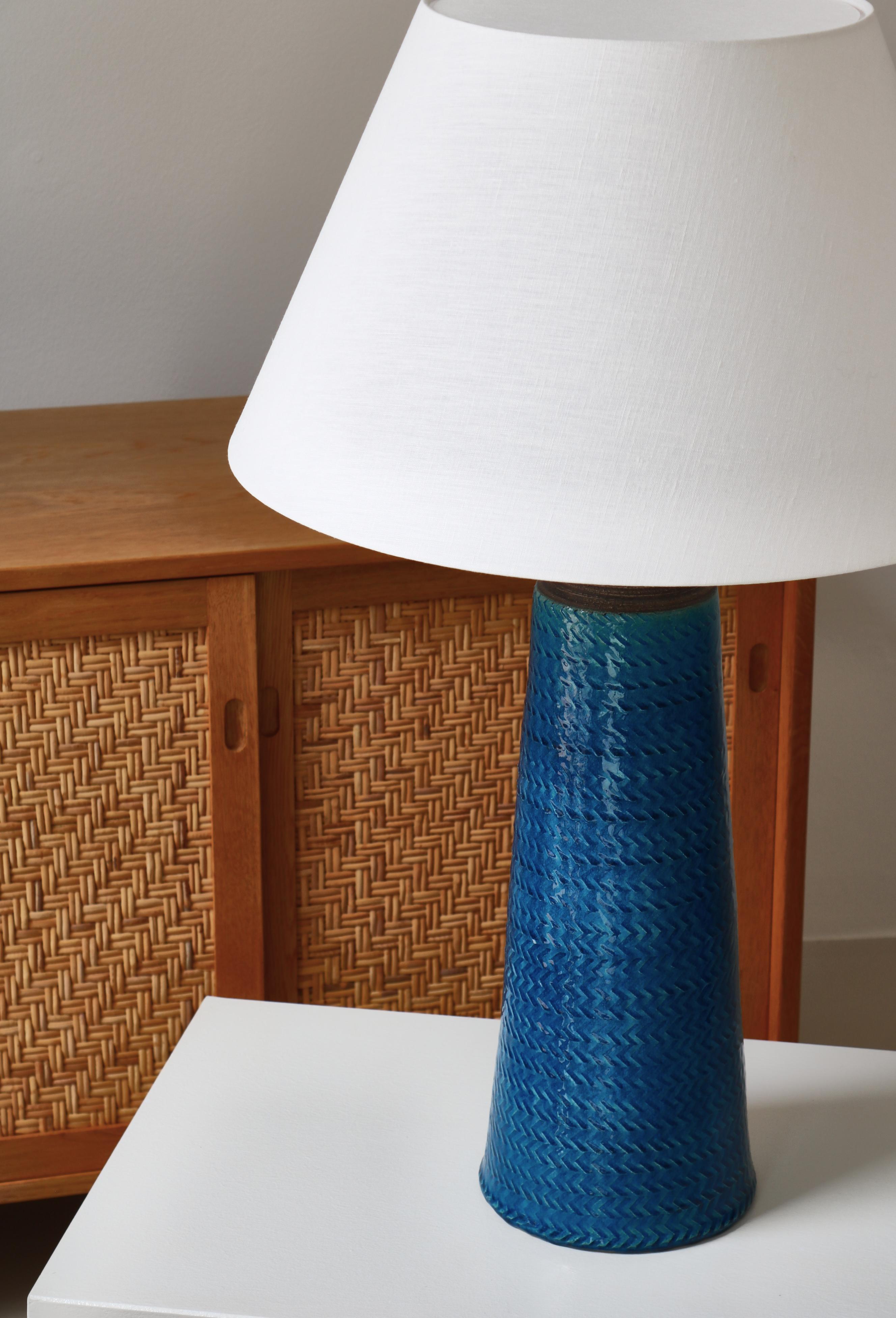 Pair of huge Scandinavian Modern table lamps made in Denmark in the 1950s at Kähler Keramik by Nils Kähler. Amazing blue glazing and the herringbone pattern adds a dynamic element to the surface of the lamp and catches the eye with its beauty and