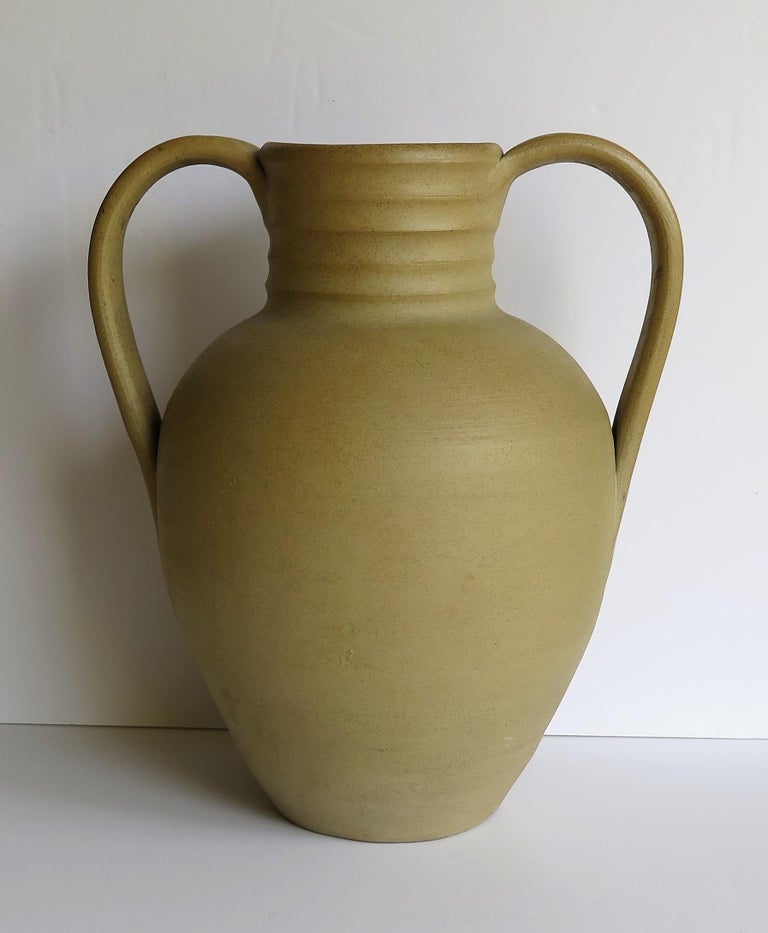 This is a large stoneware vase or urn, hand potted by the Moira Pottery Company, near Burton on Trent, Leicestershire in England. The Moira Pottery works was founded in 1922 and demolished in the 1970s.

This hand potted stoneware vase has a