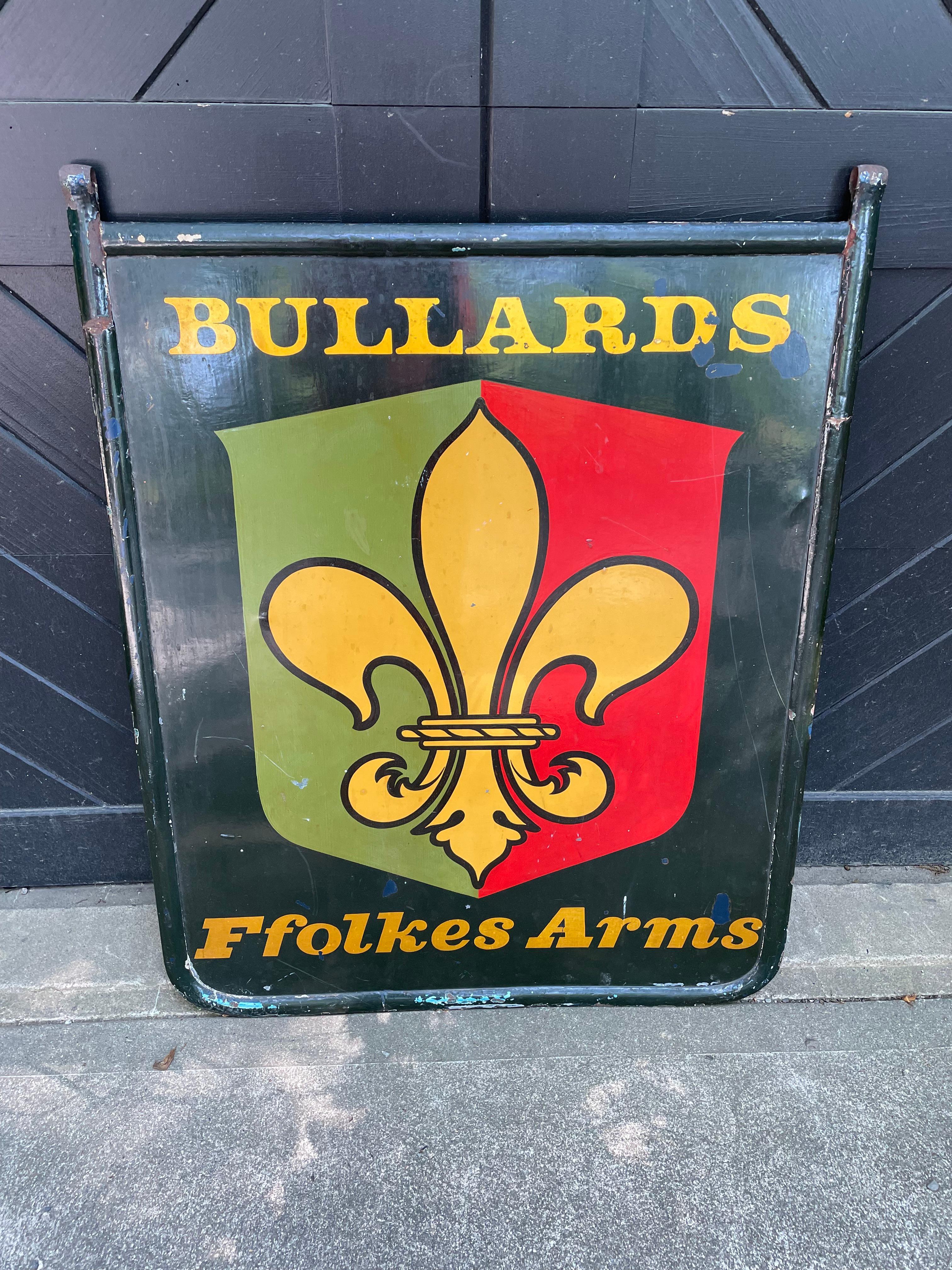 Striking vintage pub sign from England with timeless fleur di lis decoration and graphic color palette of green, red and gold against a black background.  The sign has all its authentic charm and has been intentionally left in original slightly