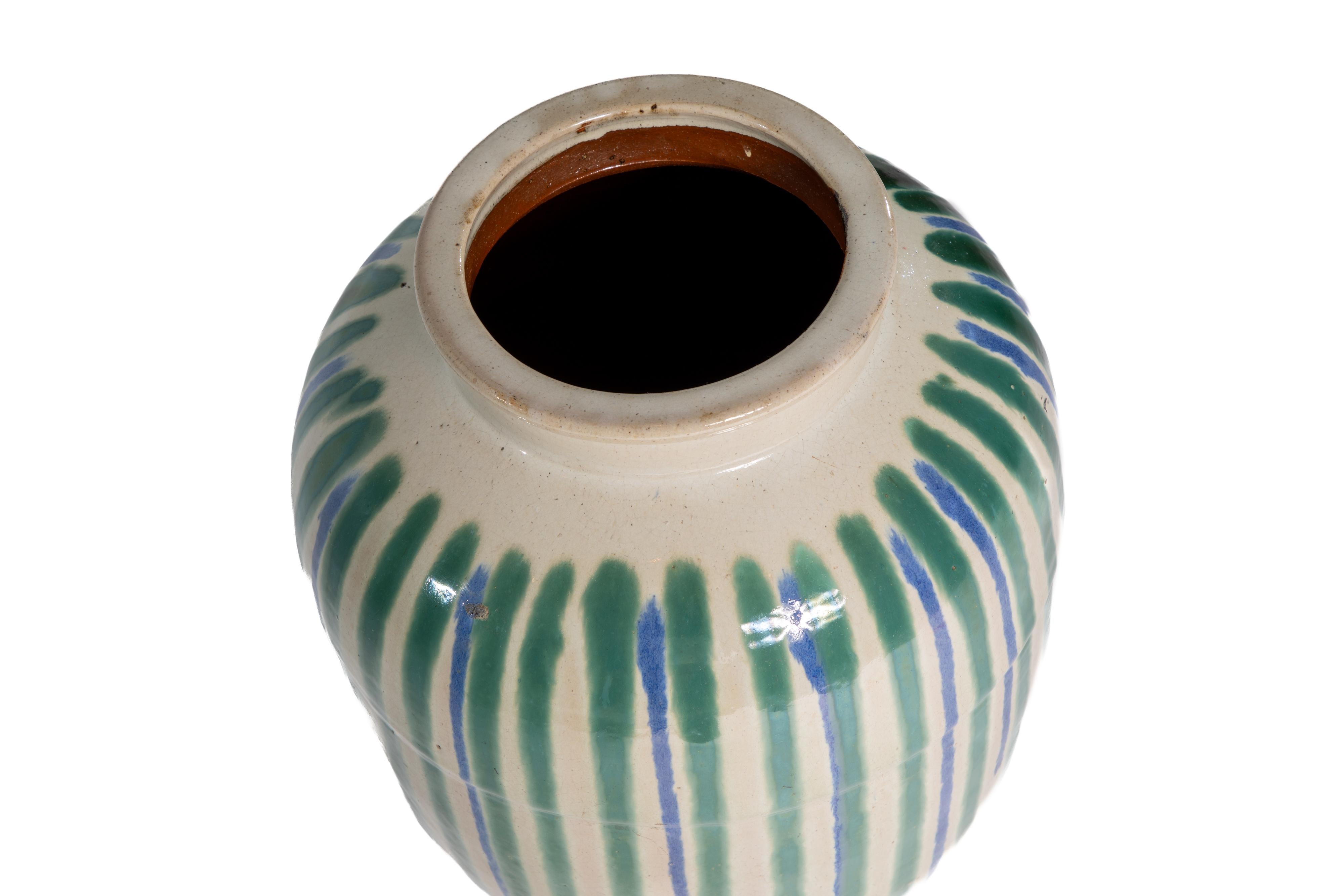 Large glazed stoneware vase of Japanese origin.  Cream base with blue and green decoration.
Marked on underside with script.