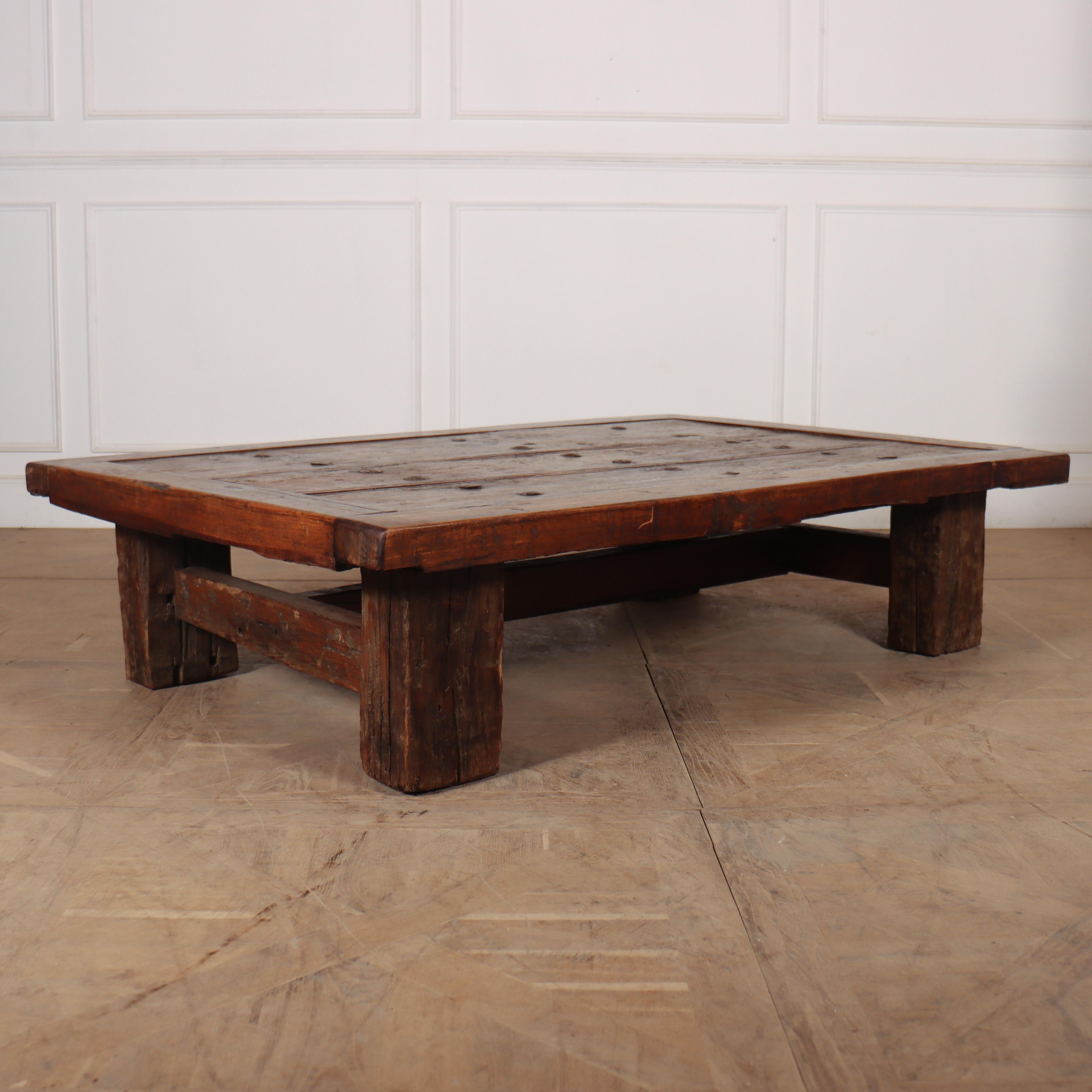 19th C studded teak and walnut door converted into a large coffee table. 1880.

2.5