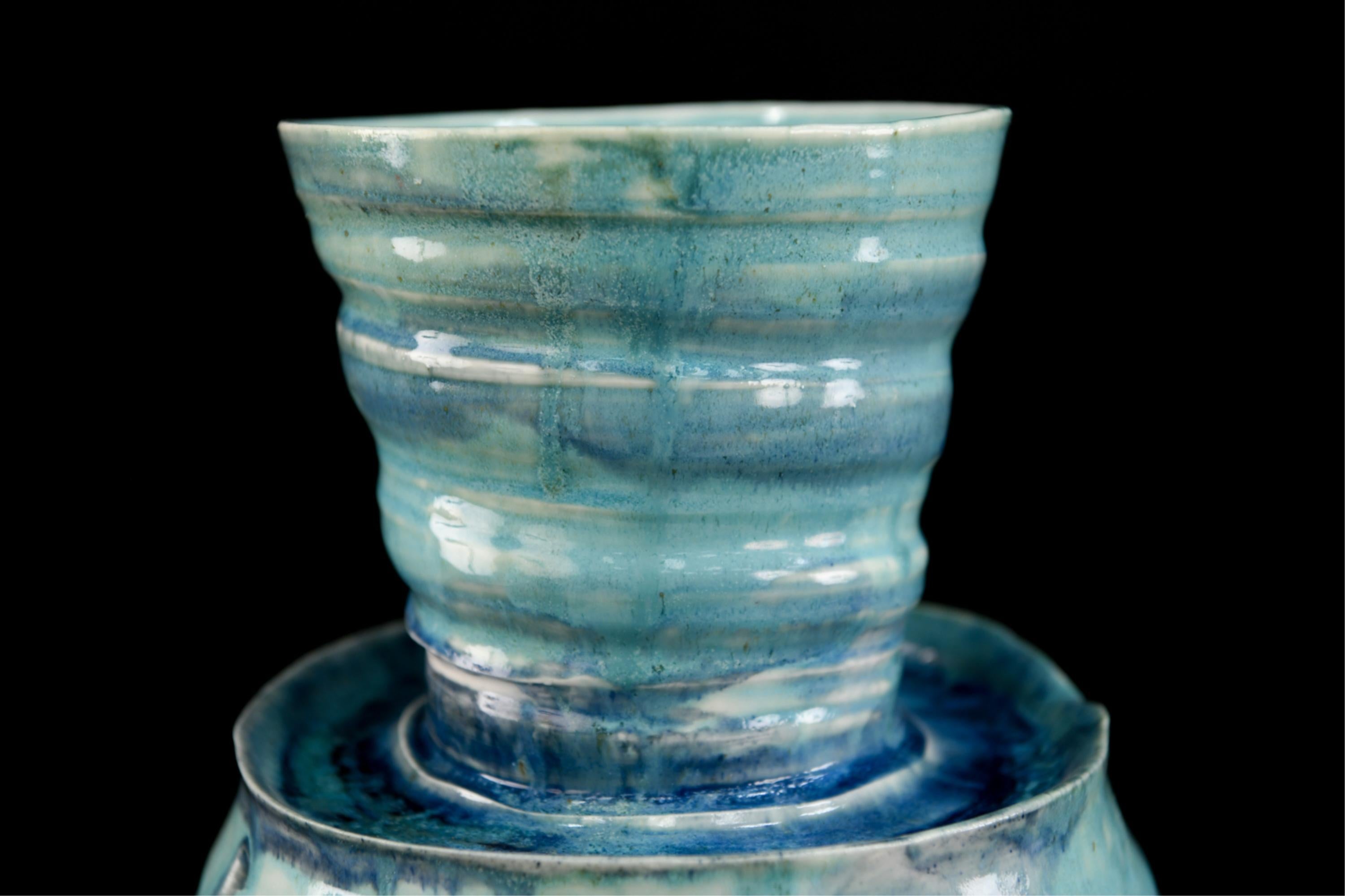 A beautiful Studio Pottery vase in turquoise blues and white glaze.
