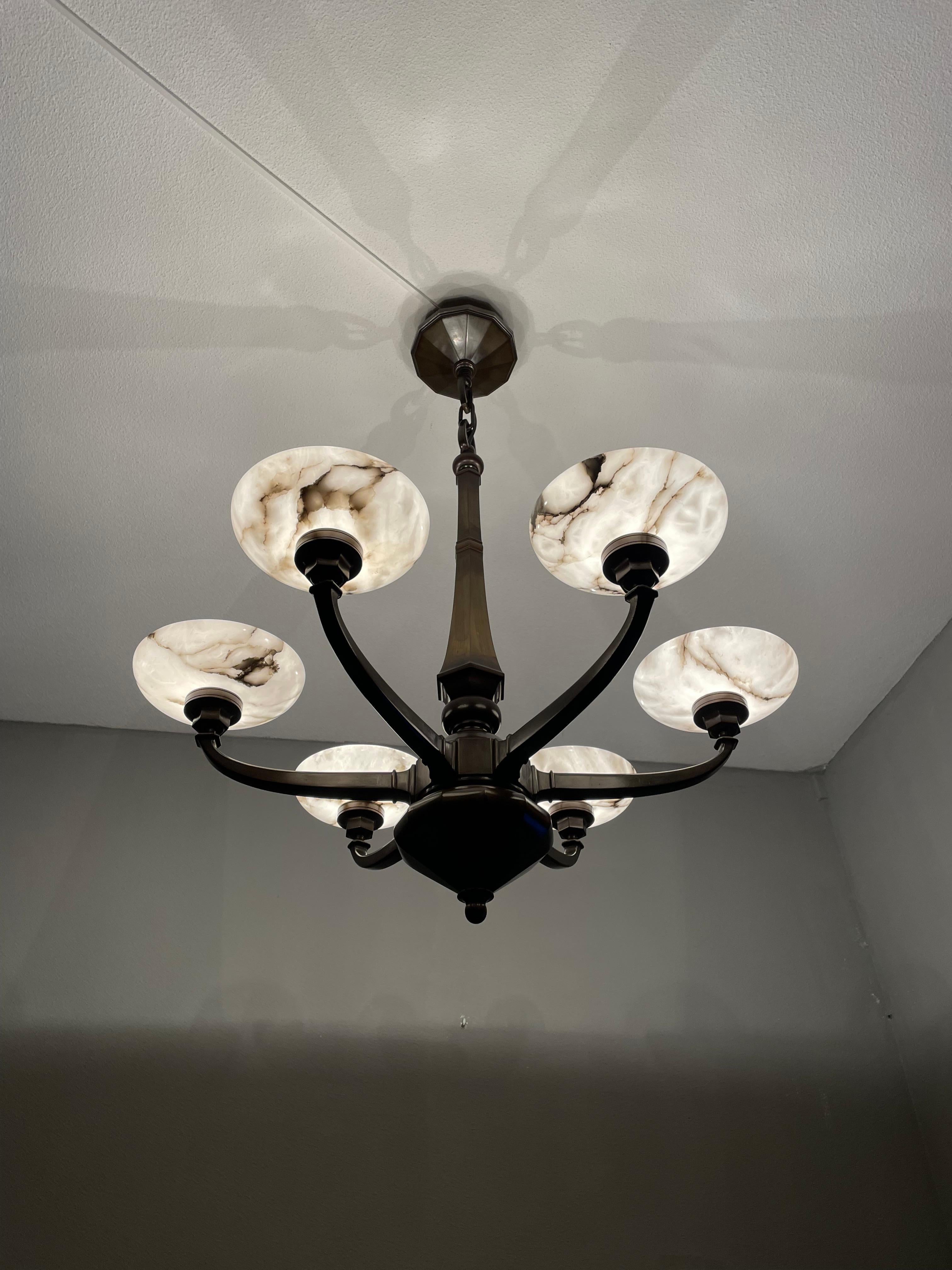 Striking and exclusive, early 1900s bronze and alabaster light fixture for the perfect atmosphere.

If you are looking for a remarkable light fixture to grace your living space then this antique yet timeless chandelier from circa 1910 could very