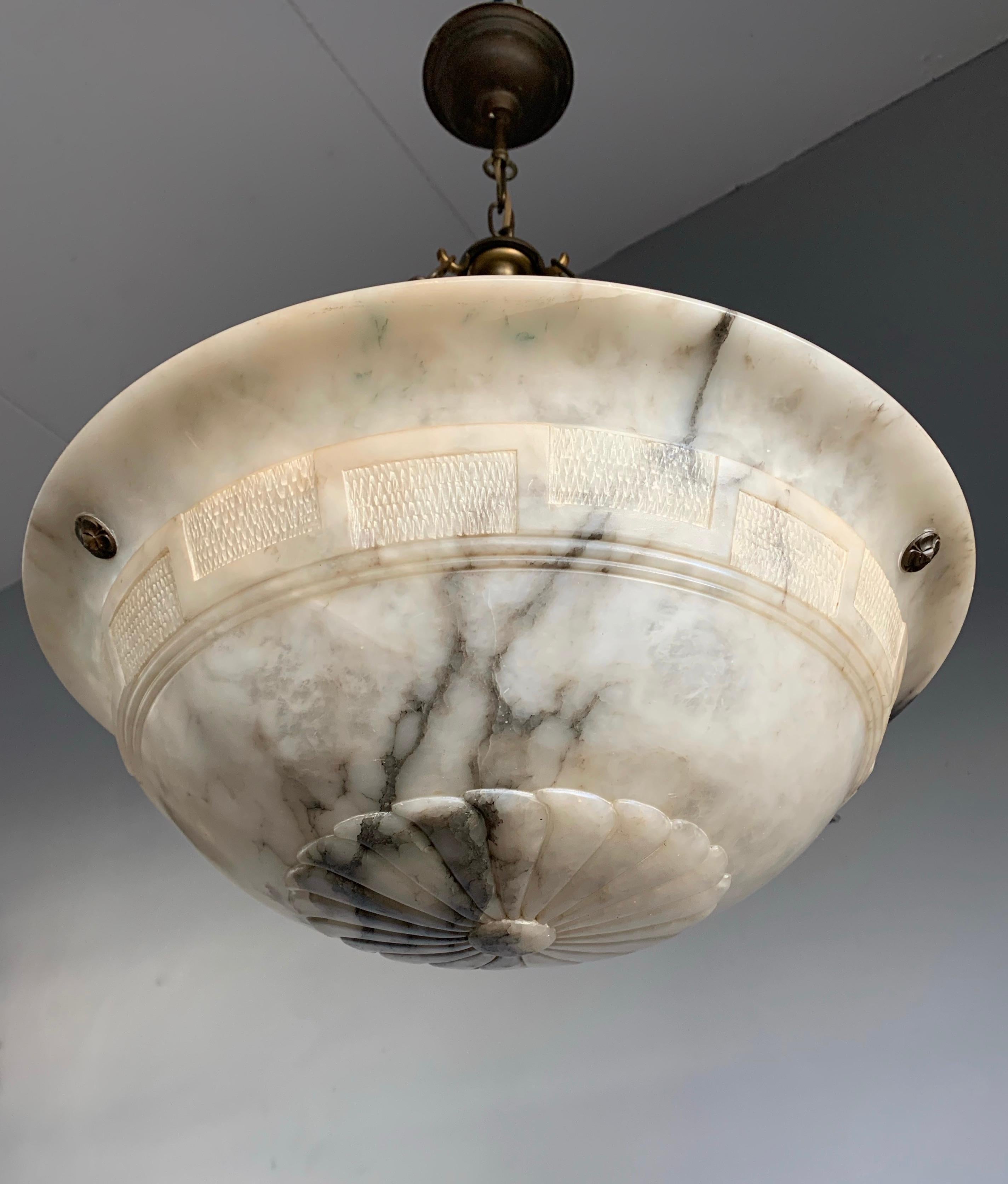 Superb condition chandelier with a stunning and great size alabaster shade.

Thanks to its large & deep size and remarkable design this alabaster chandelier will light up both your days and evenings. It is in excellent condition from top to bottom