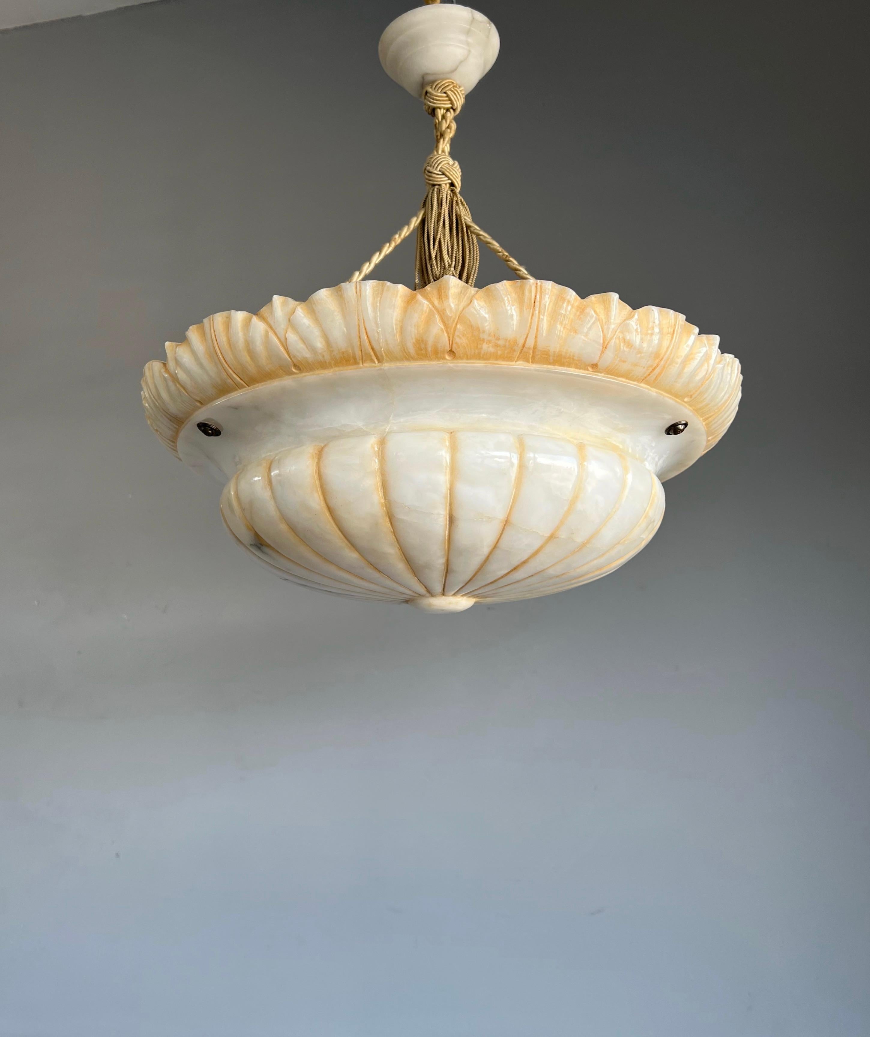 Large size and great design, hand carved, antique alabaster chandelier.

Thanks to its large size and unique design this antique and remarkable alabaster chandelier will be a real eyecatcher in your interior. This one of a kind specimen is in very