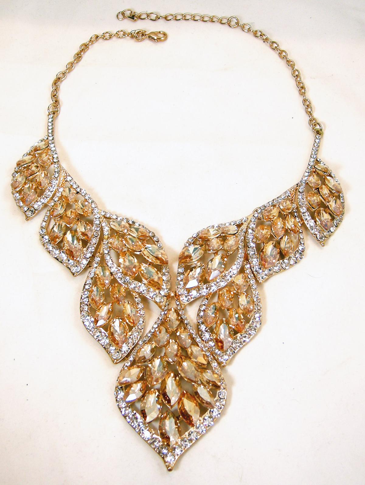 This stunning bib necklace has citrine crystals with clear crystal accents in a gold tone setting.  In excellent condition, this necklace measures 19-1/2” long with a spring clasp. The front drop, top to bottom, measures 3-1/2”.