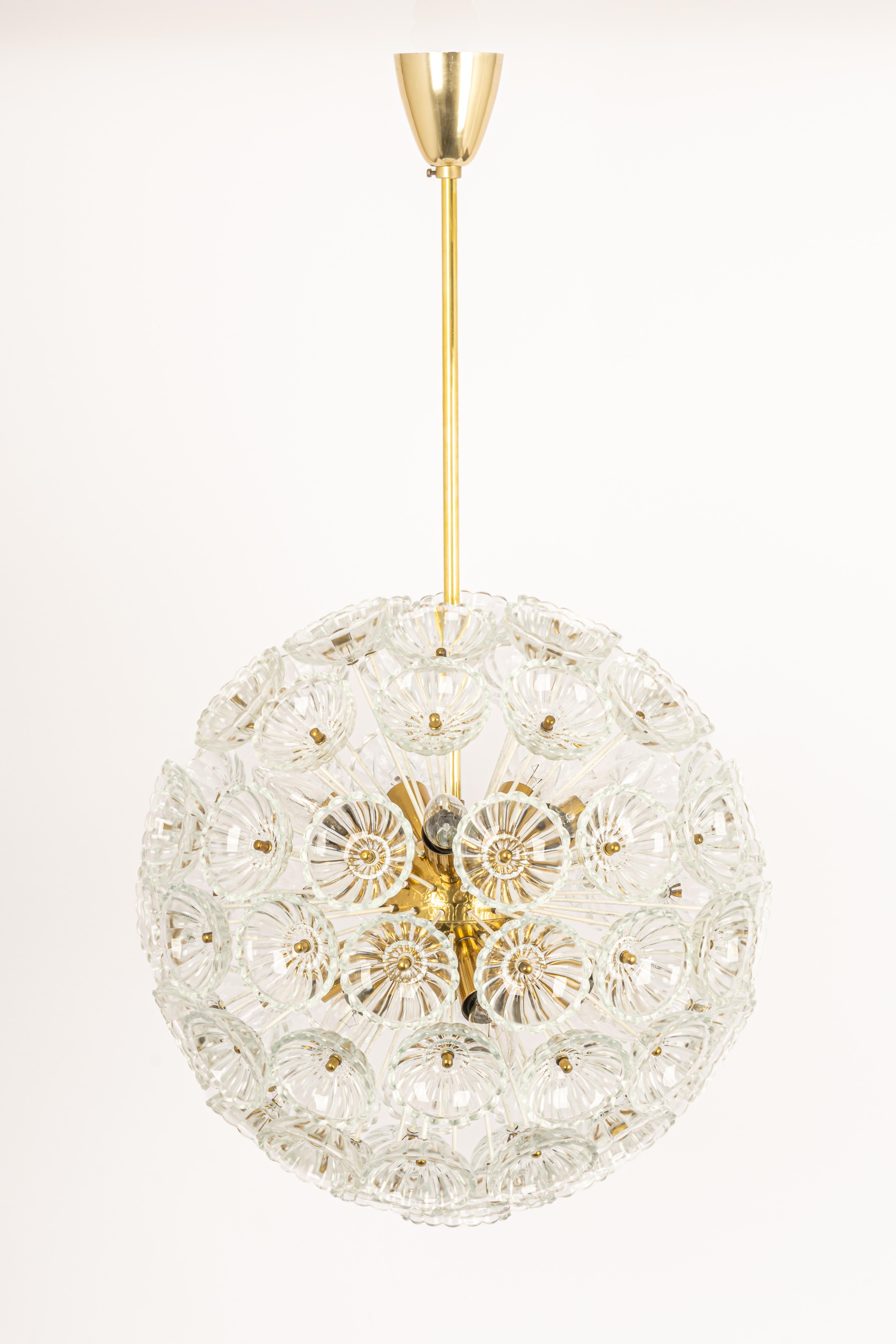Stunning floral glass and brass Sputnik chandeliers, Germany, 1960s.

It requires 14 x E14 small bulbs with 40W max each.
Light bulbs are not included. It is possible to install this fixture in all countries (US, UK, Europe, Asia,