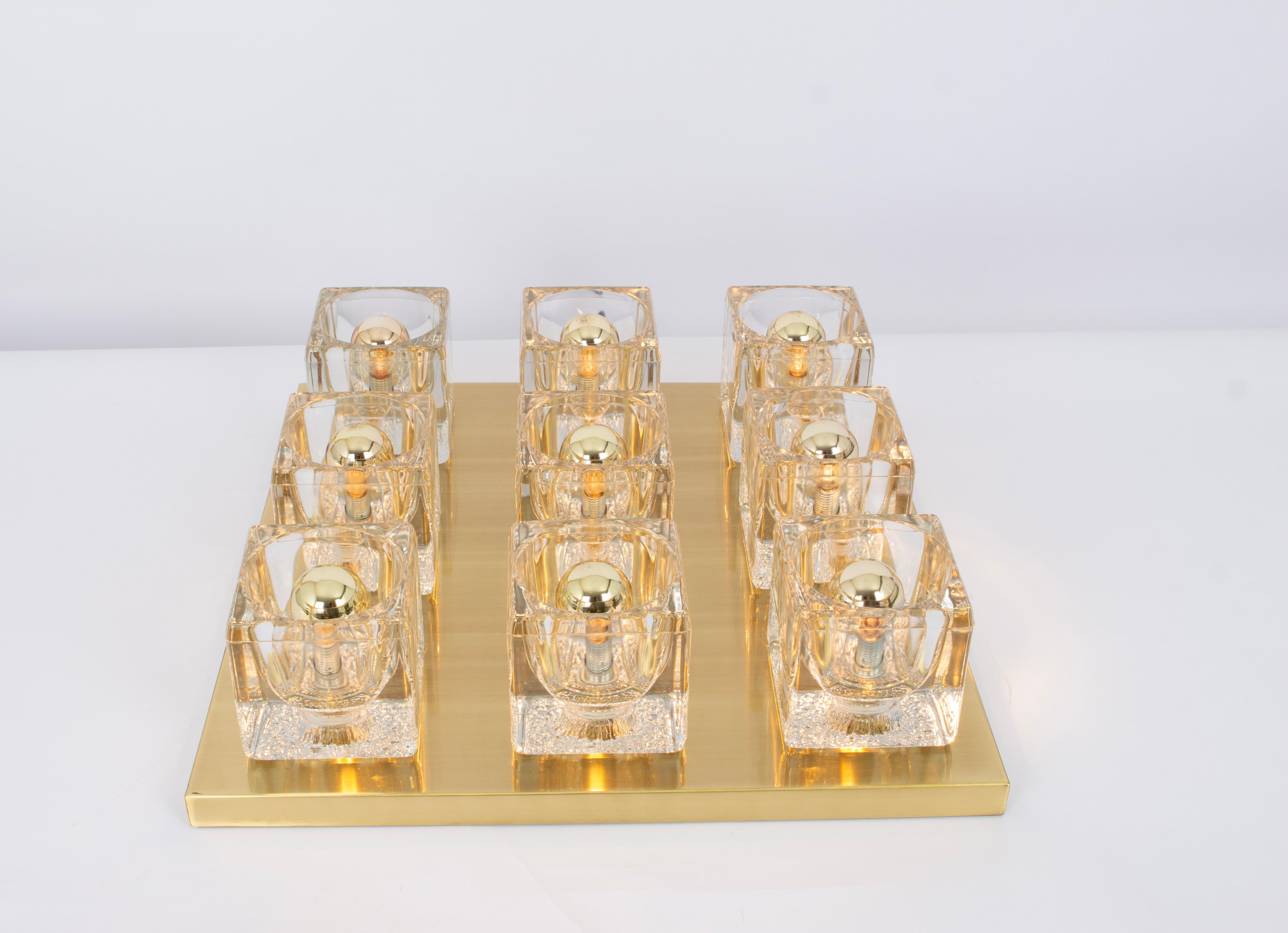 Fantastic mid-century flush mount by Peill & Putzler, Germany, manufactured, circa 1970-1979. 
9 Cube glasses over a brass frame.
High quality and in very good condition. Cleaned, well-wired, and ready to use. 
Gorgeous Light effect.

The fixture