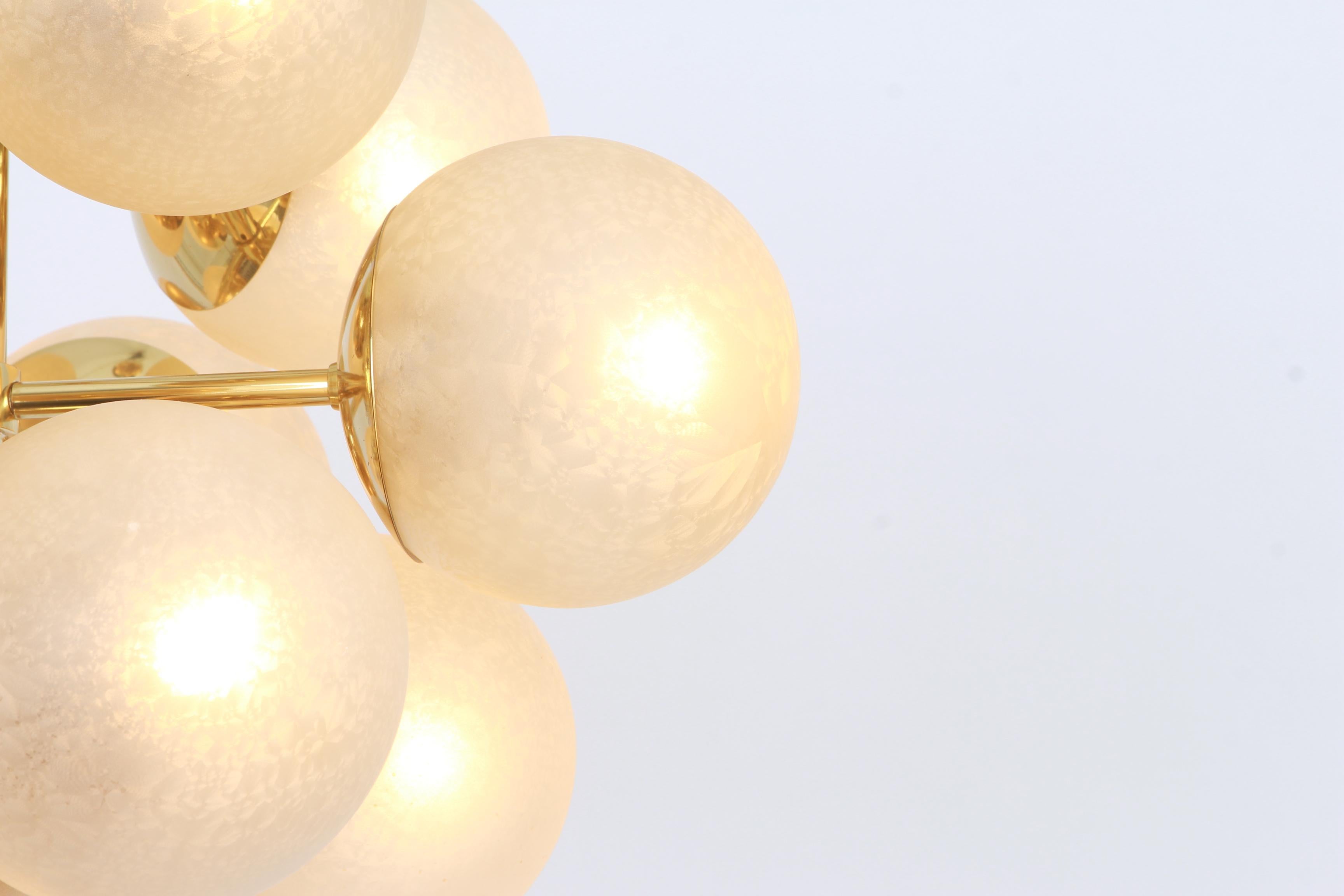 Stunning Sputnik brass chandelier with 13 handmade glass globes by Kaiser Leuchten, Germany, 1960s.

High quality and in very good condition. Cleaned, well-wired and ready to use. 

The fixture requires 13 x E14 small bulbs with 40W max each and