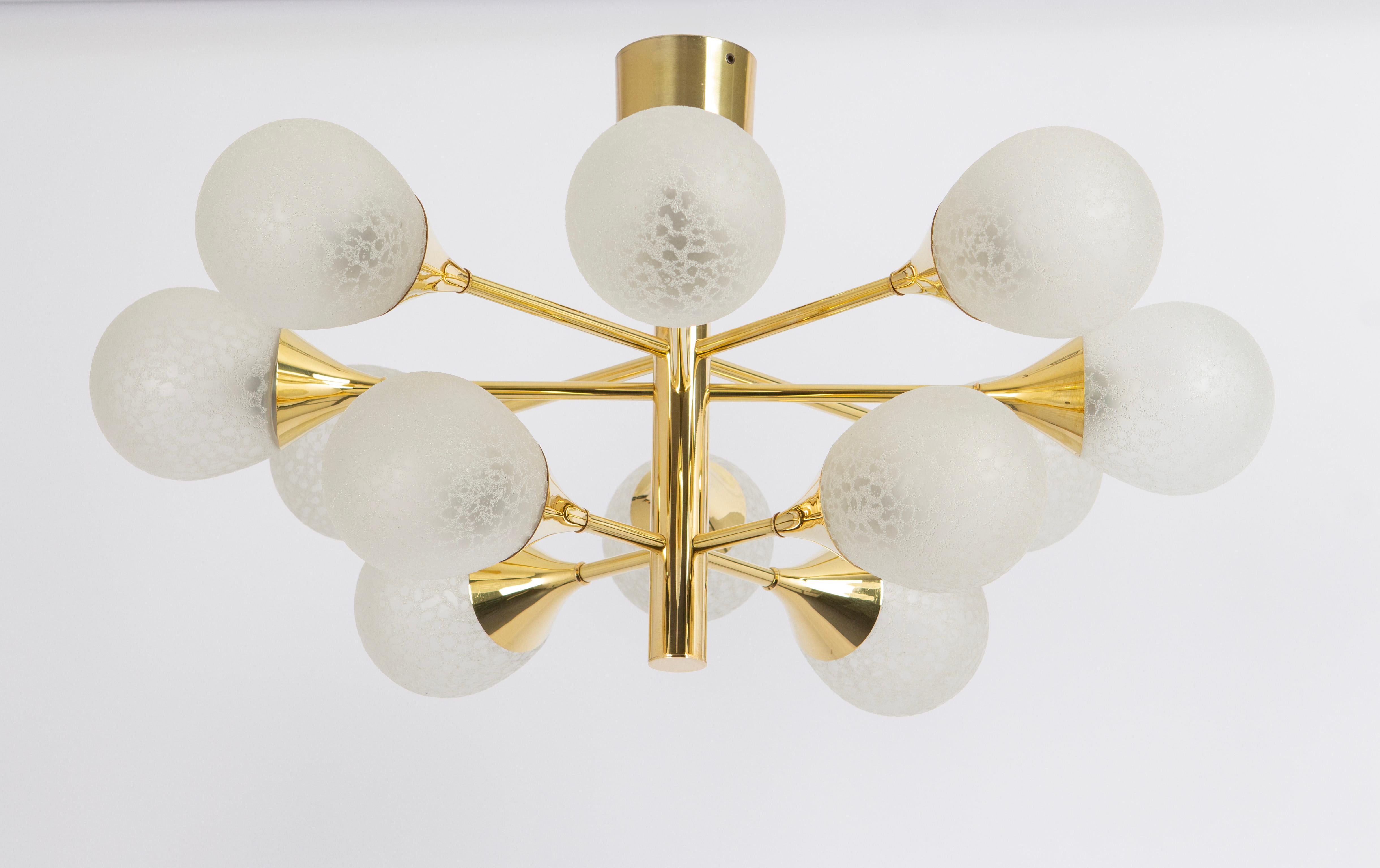 Stunning Sputnik brass chandelier with 12 glass globes by Kaiser Leuchten, Germany, 1970s.
High quality and in very good condition. Cleaned, well-wired, and ready to use. 

The fixture requires 12 x E14 small bulbs with 40W max each.
Light bulbs are