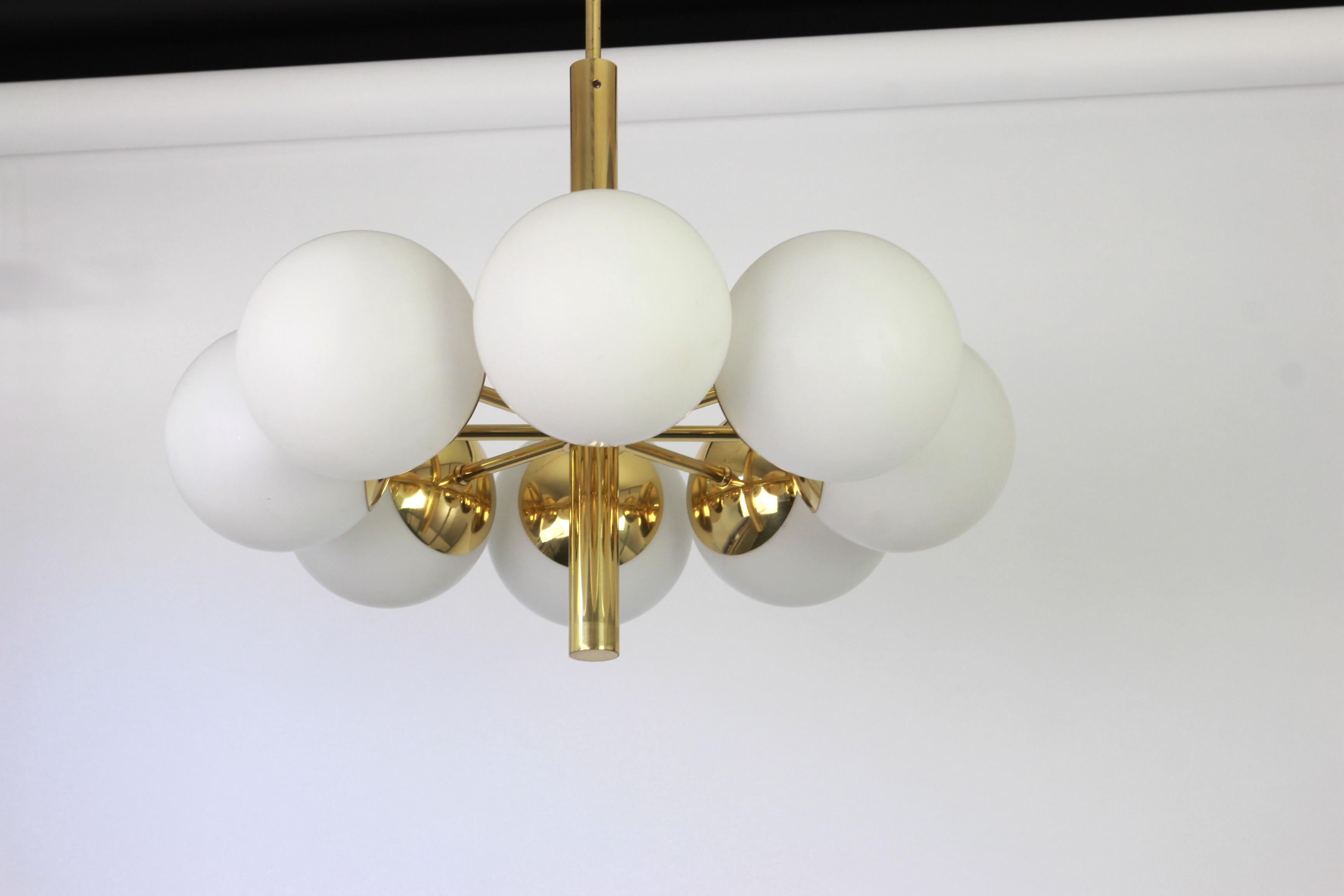 Stunning radial Sputnik brass chandelier with eight opal glass globes by Kaiser Leuchten, Germany, 1960s.

High quality and in very good condition. Cleaned, well-wired and ready to use. 

The fixture requires 8 x E14 standard bulbs with 40W max