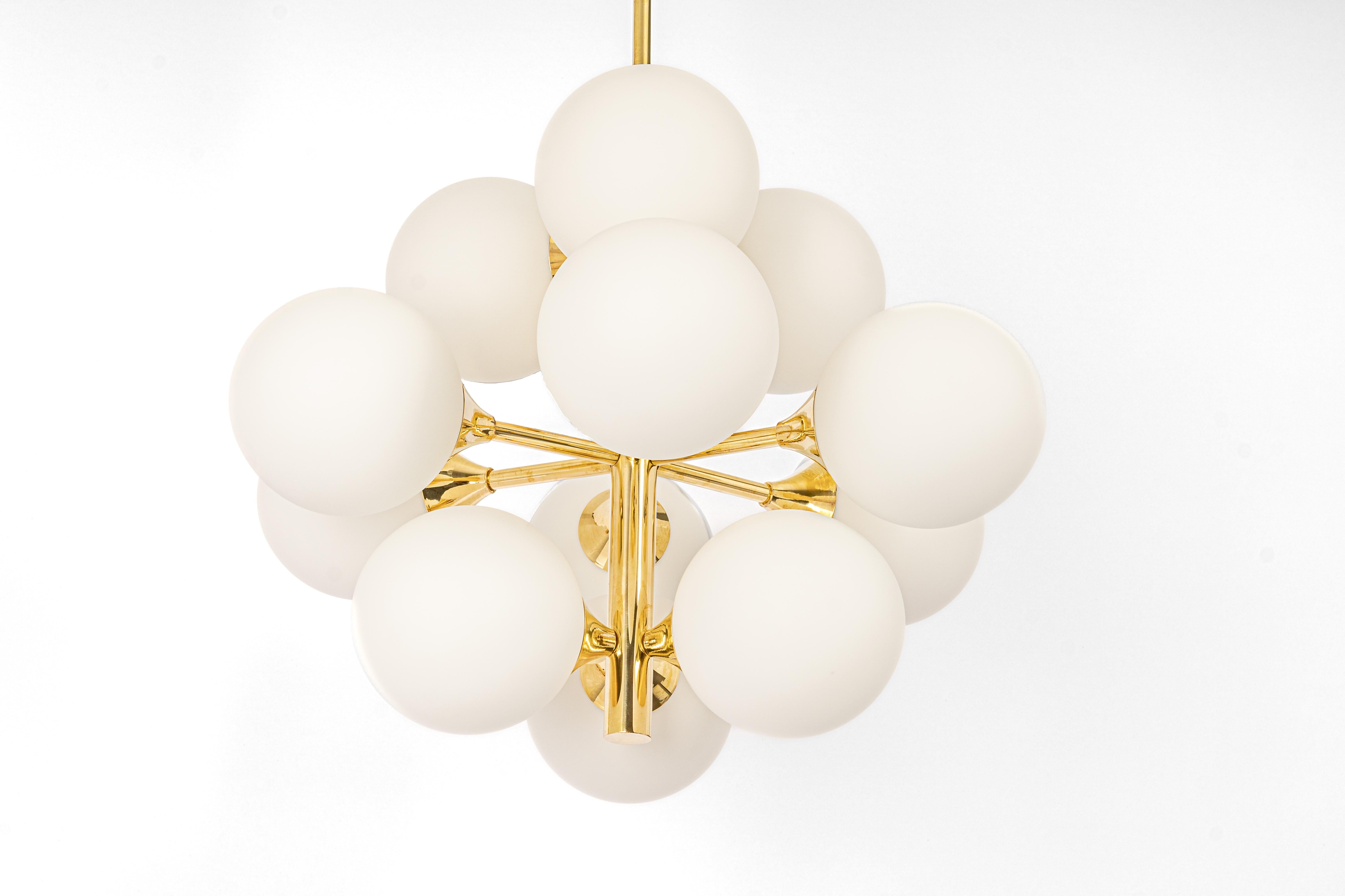 Stunning Sputnik brass chandelier with 12 opal glass globes by Kaiser Leuchten, Germany, 1960s.
High quality and in very good condition. Cleaned, well-wired, and ready to use. 

The fixture requires 12 x E14 standard bulbs with 40W max