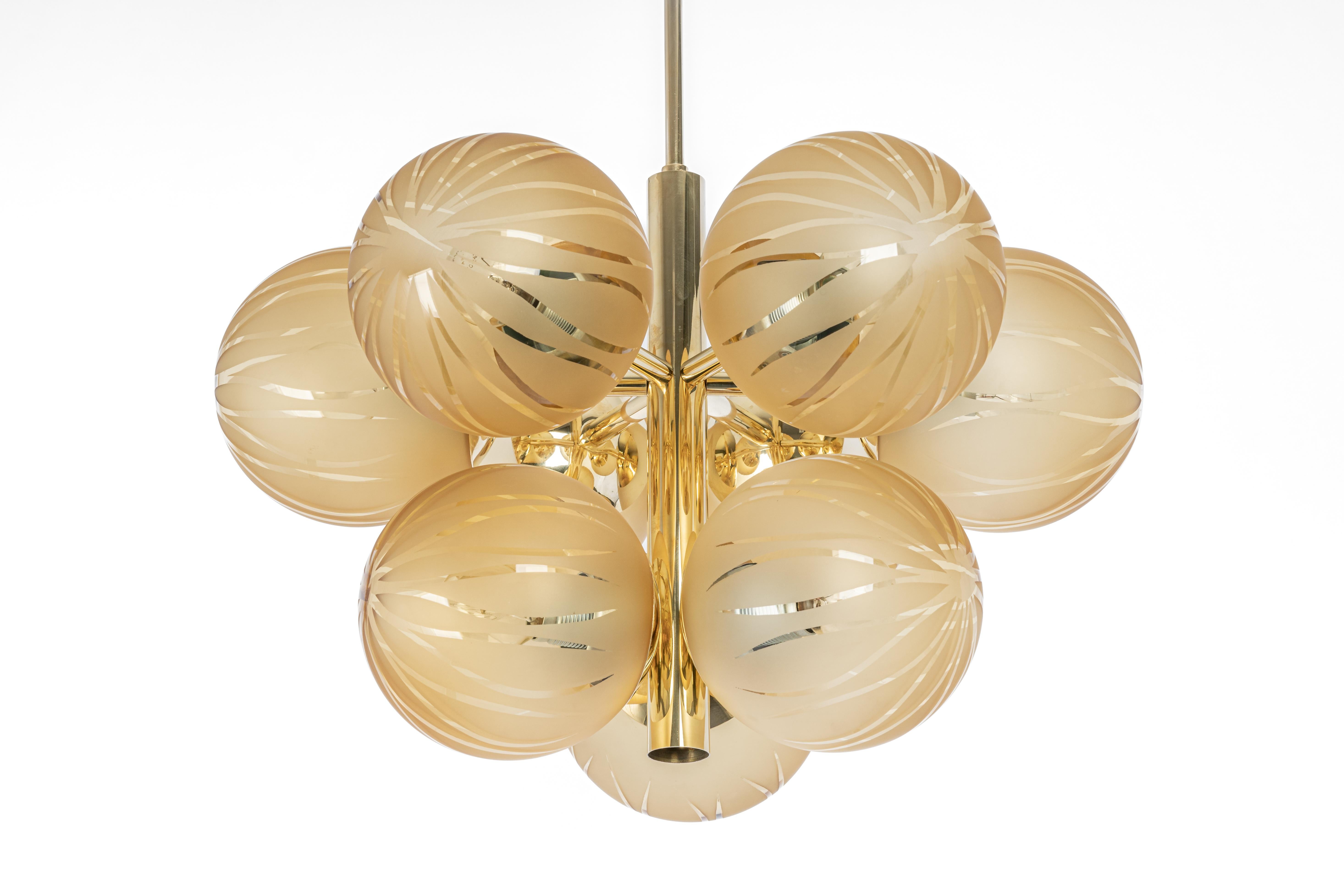 Stunning Sputnik brass chandelier with 8 glass globes by Kaiser Leuchten, Germany, 1970s.
High quality and in very good condition. Cleaned, well-wired, and ready to use. 

The fixture requires 8 x E14 standard bulbs with 40W max each.
Light