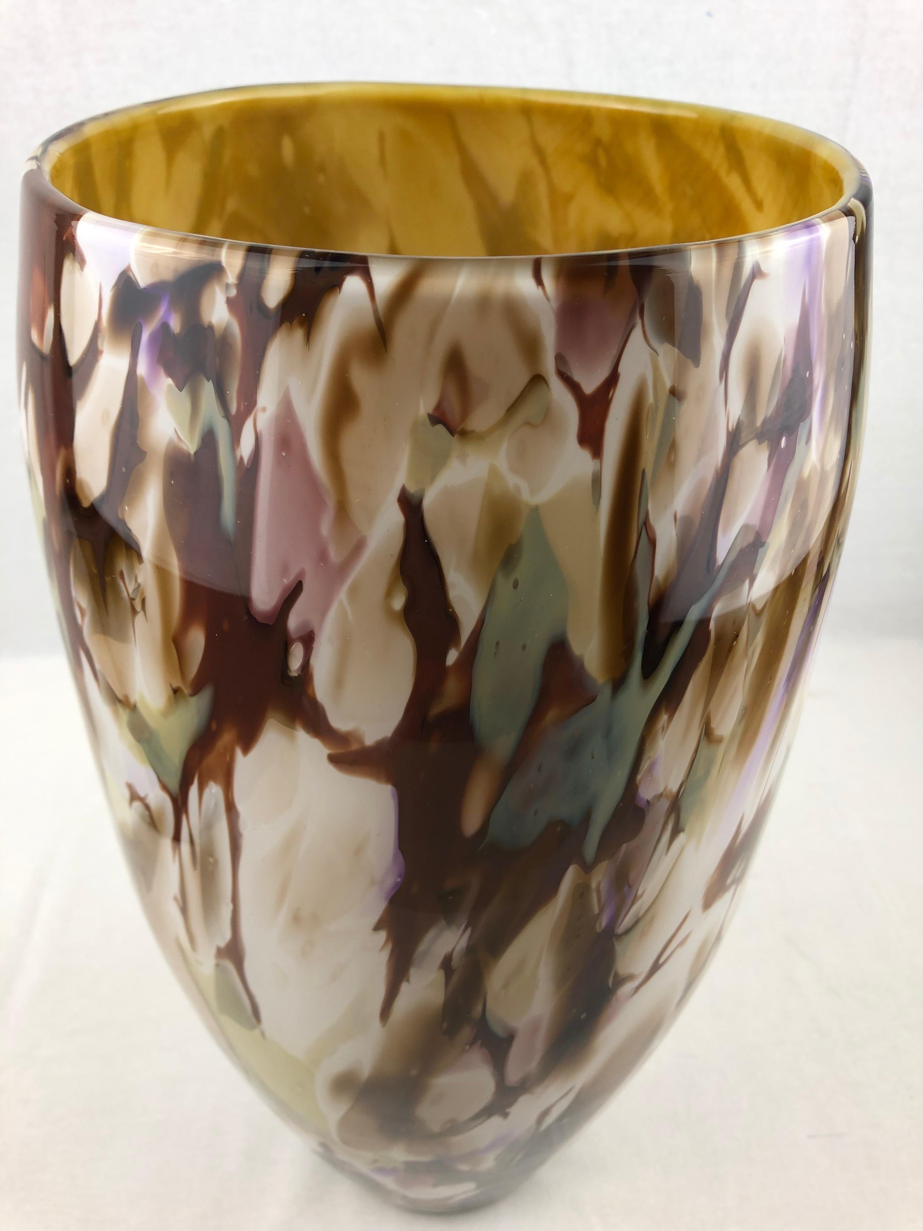 A stunning multicolored Murano art glass vase from Italy. Dating back to the late 1960s, this vase is an attractive addition to any room. It's structure lends a unique elegant eye-catching presence and surely to enhance any shelf, table, or