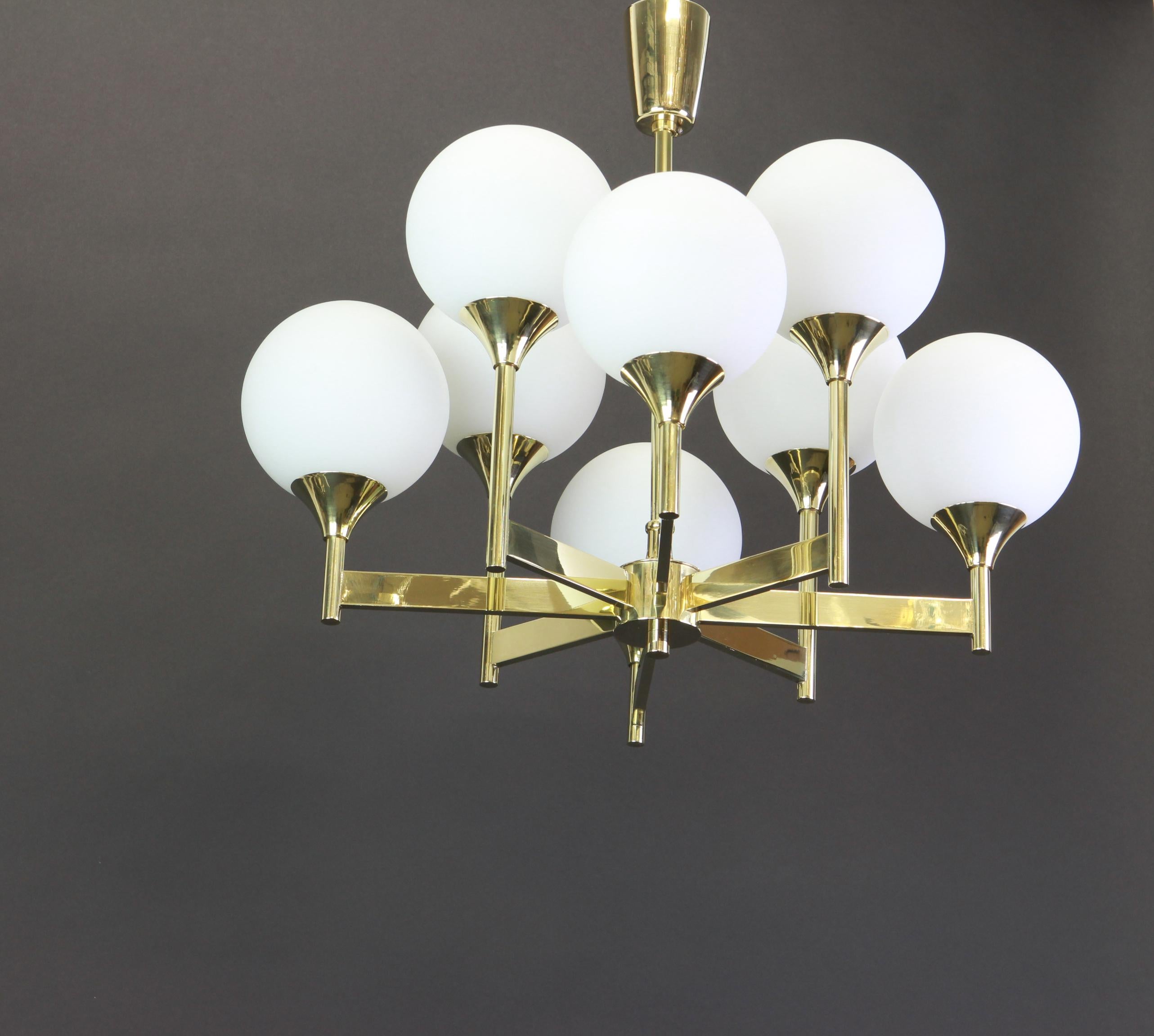 Stunning Sputnik brass chandelier with eight opal glass globes by Kaiser Leuchten, Germany, 1960s.

Heavy quality and in very good condition. Cleaned, well-wired and ready to use. 

The fixture requires eight E14 small bulbs with 40W max each