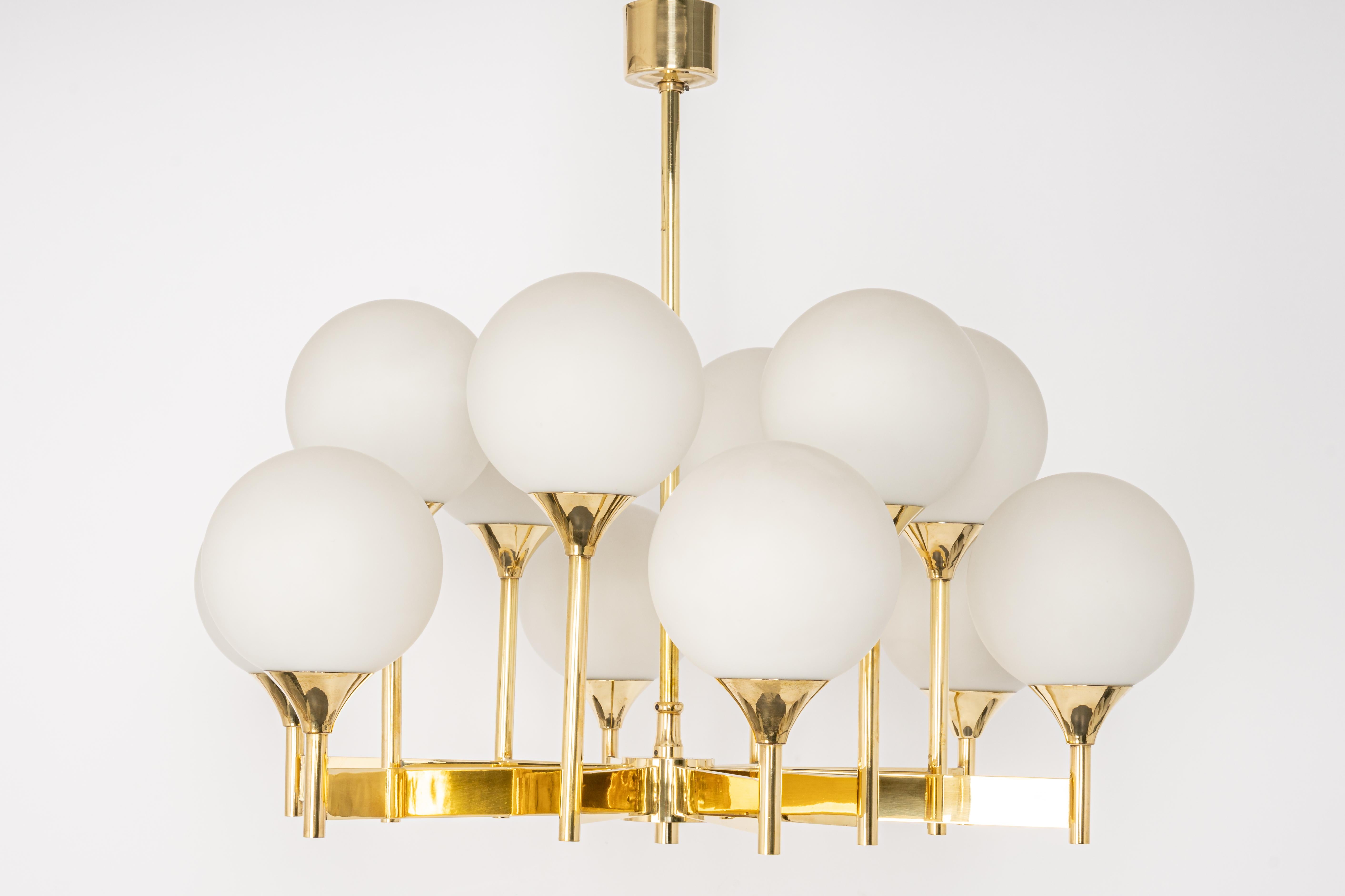 Stunning Sputnik brass chandelier with eight opal glass globes by Kaiser Leuchten, Germany, 1960s.

Heavy quality and in very good condition. Cleaned, well-wired and ready to use. 

The fixture requires 12 x E14 small bulbs with 40W max