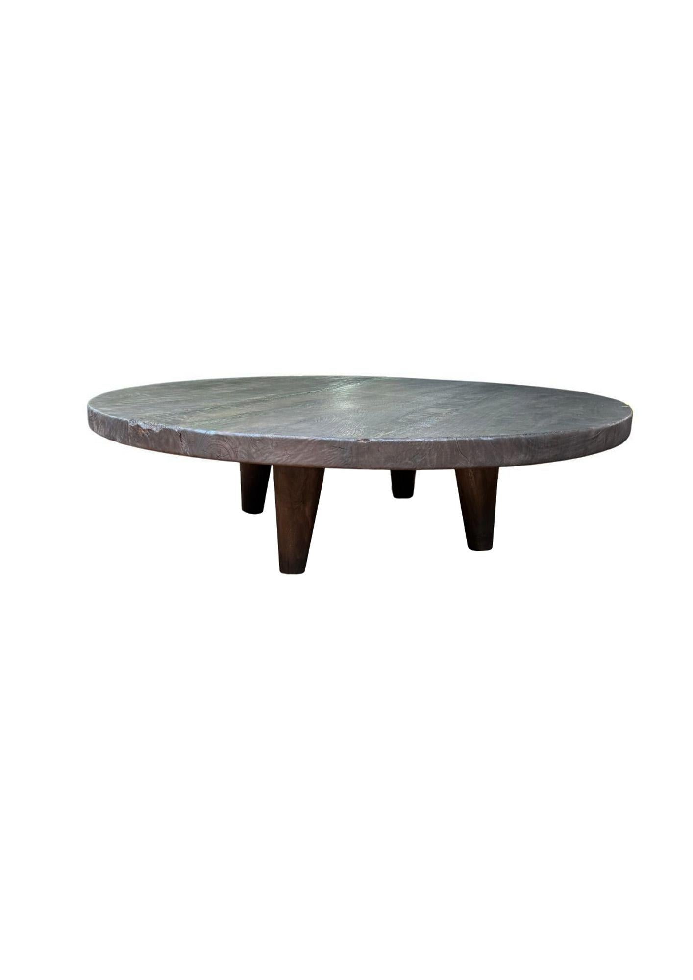 Elevate your living space with the bold elegance of this Large Suar Wood Round Table, handcrafted from solid Suar wood and finished in a rich, dark 