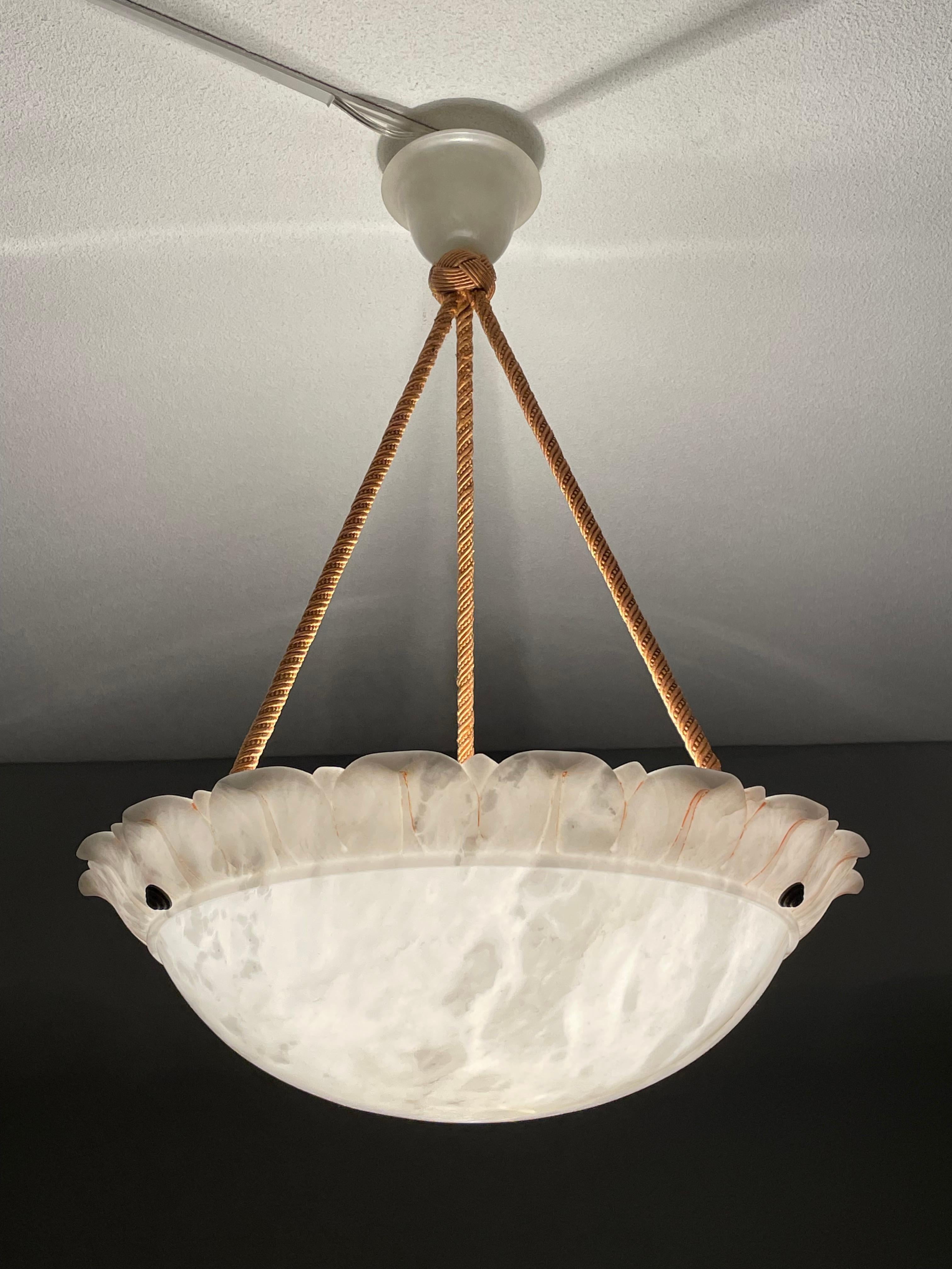 Top class, Arts and Crafts era chandelier with a stylized flower shade and perfect canopy.

Thanks to its large size, truly unique design and superb condition this alabaster chandelier will light up both your days and evenings. It is all