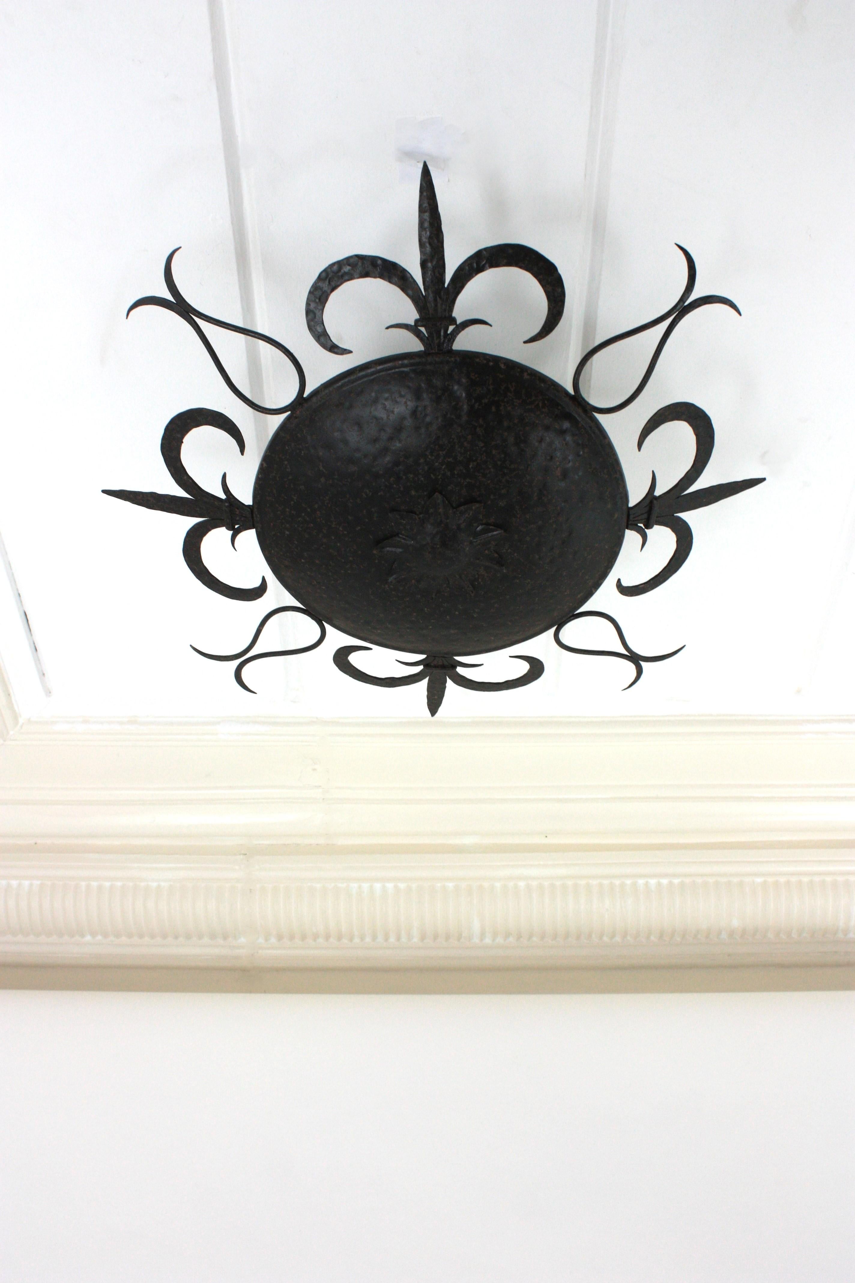 Forged Large Sunburst Ceiling Light Fixture in Wrought Iron, Fleur de Lys Motifs, 1940s For Sale