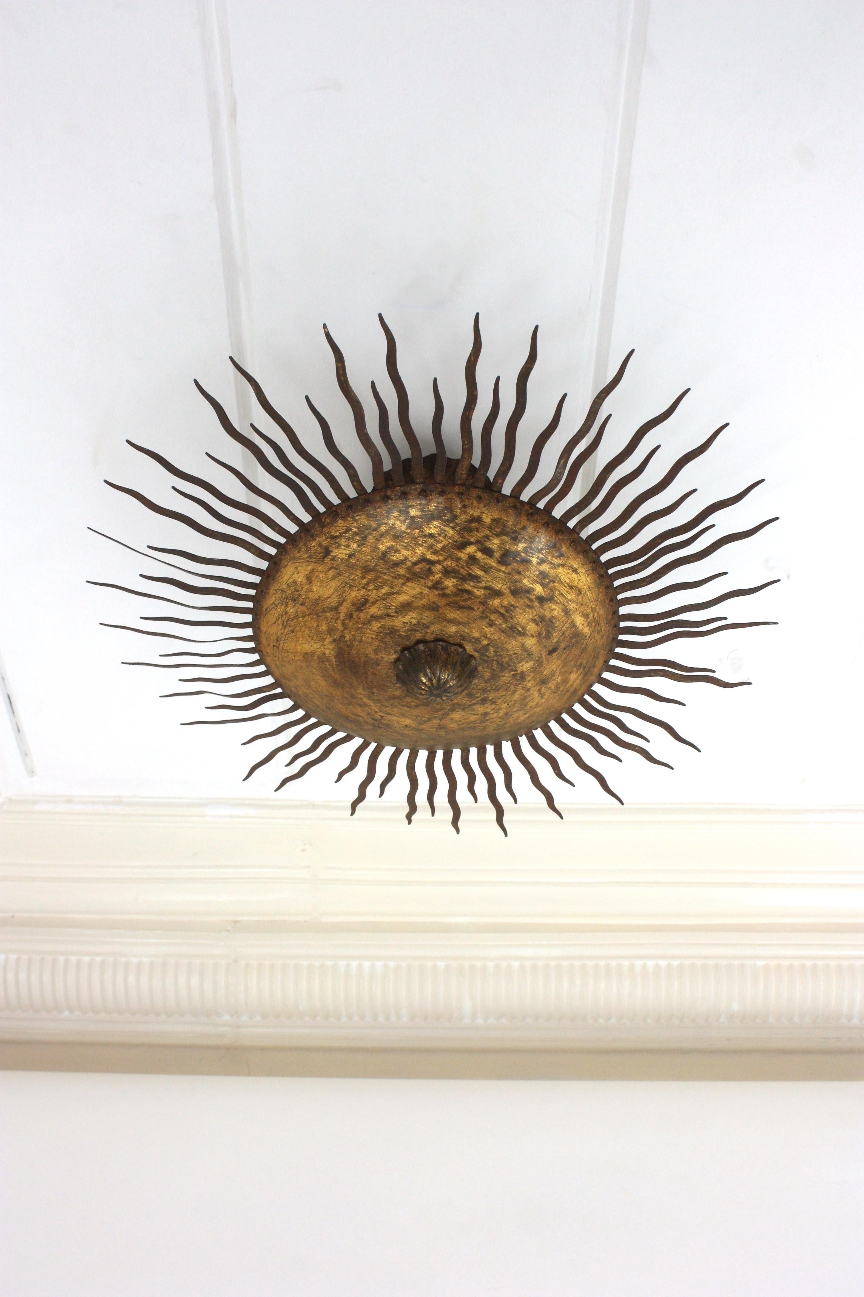 Lámpara de araña Sunburst grande con rayos rizados en hierro dorado siglo XX en venta