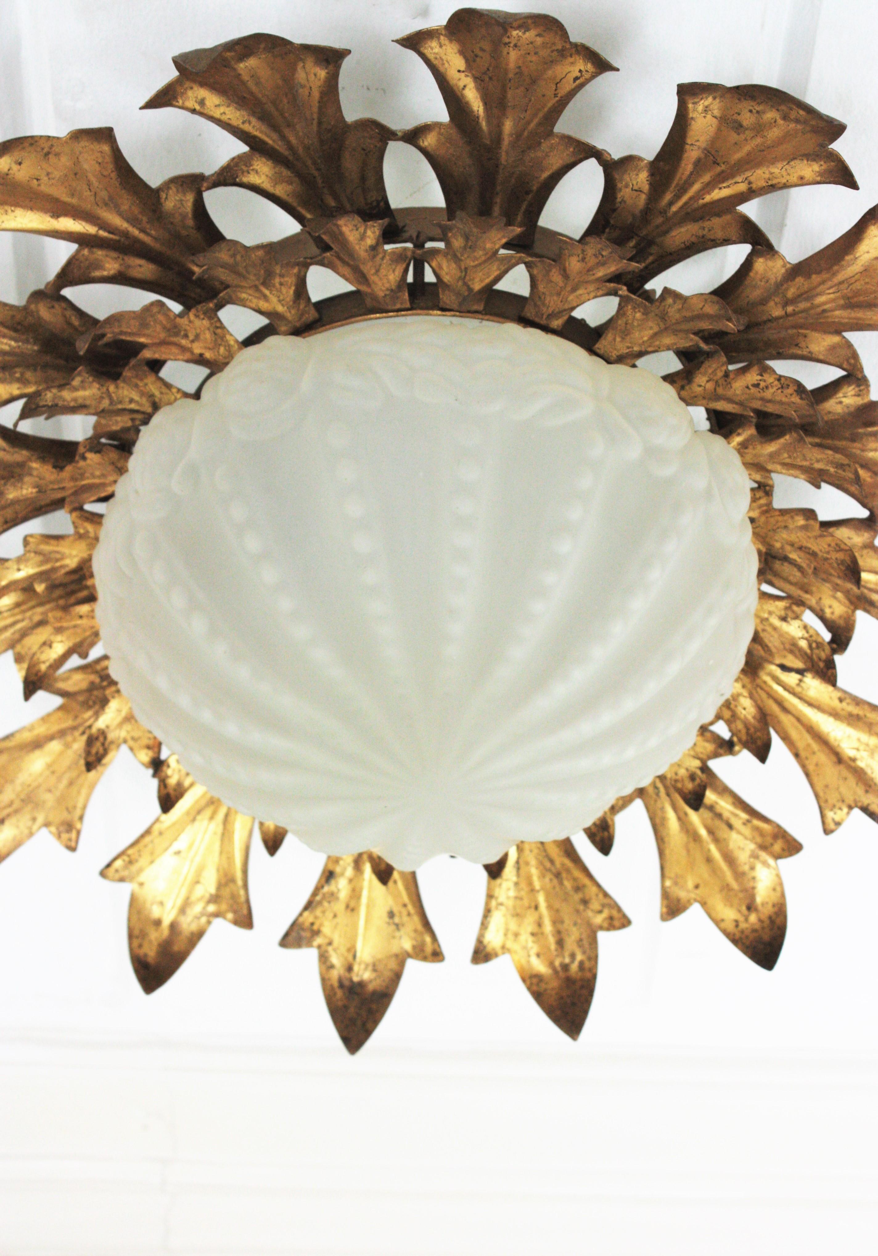 20th Century Large Sunburst Flush Mount in Gilt Iron with Frosted Glass Globe For Sale