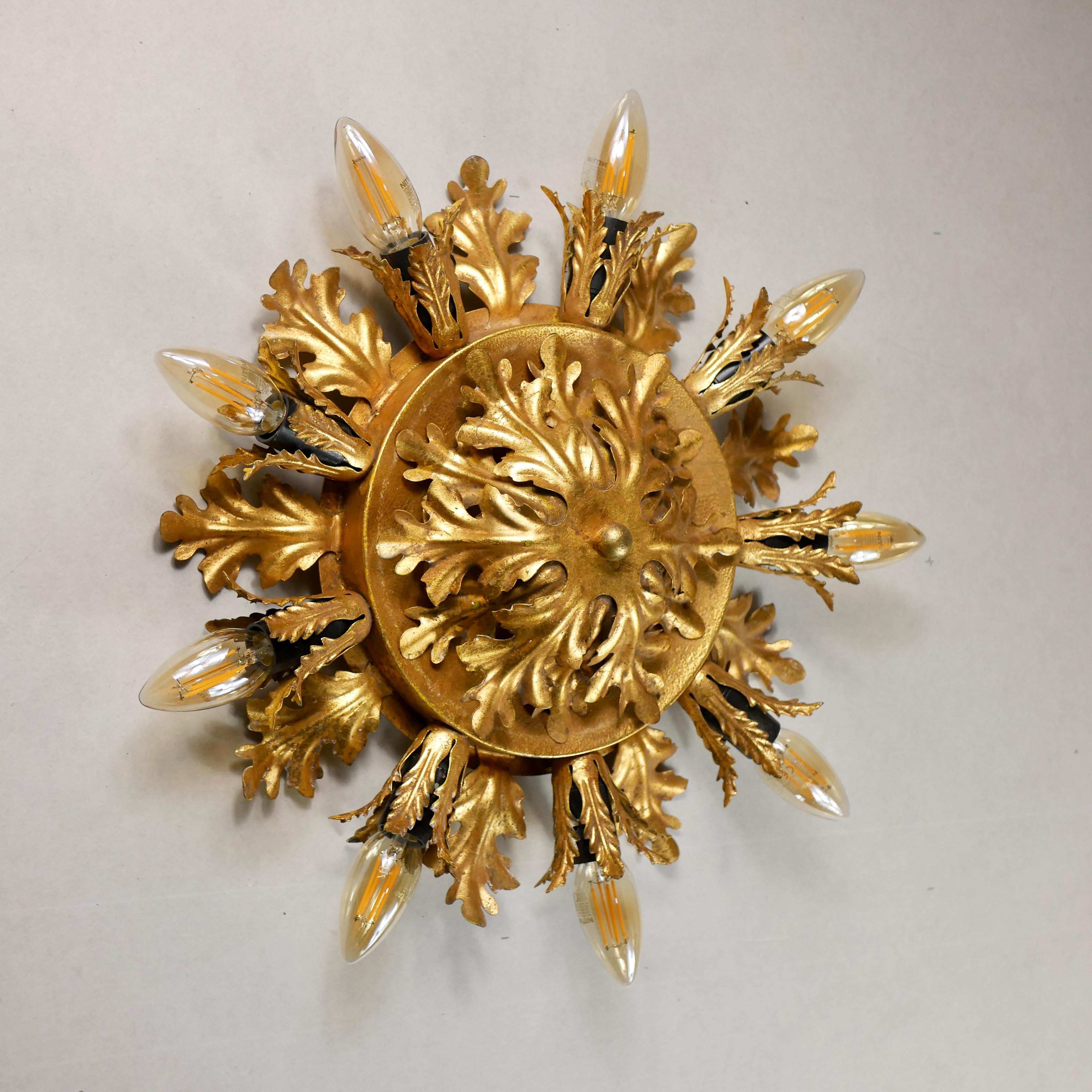 Spectacular ceiling light or wall light by Banci Firenze, made in Italy in the 1980s.
Sunburst shape, with gilded acanthus leaves.
Brought directly from Florence.
Dimensions : diameter 40cm (or 48cm with the bulbs), depth 11cm.
