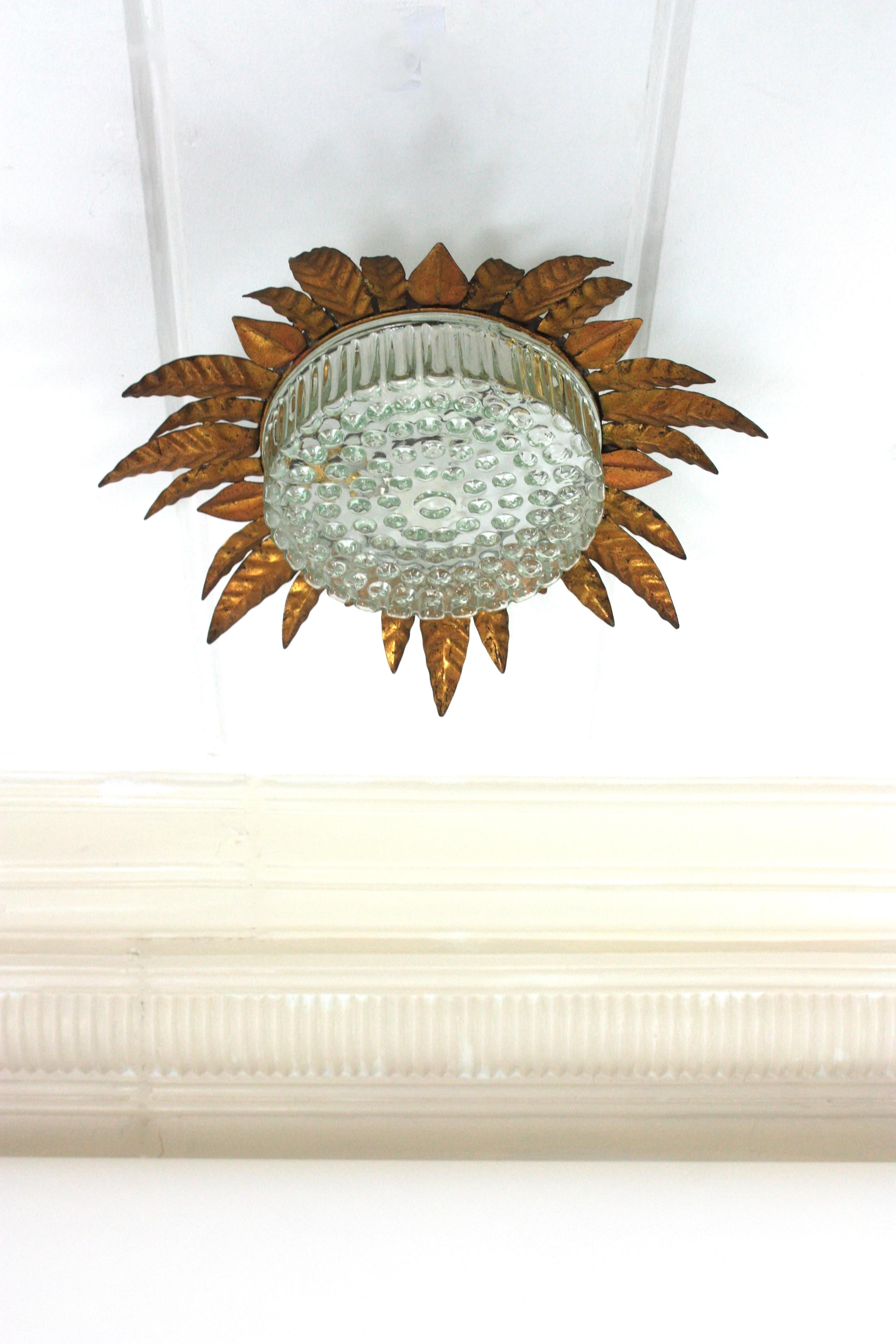 Mid-Century Modern Large Sunburst Leafed Ceiling Light Fixture in Gilt Iron and Pressed Glass For Sale