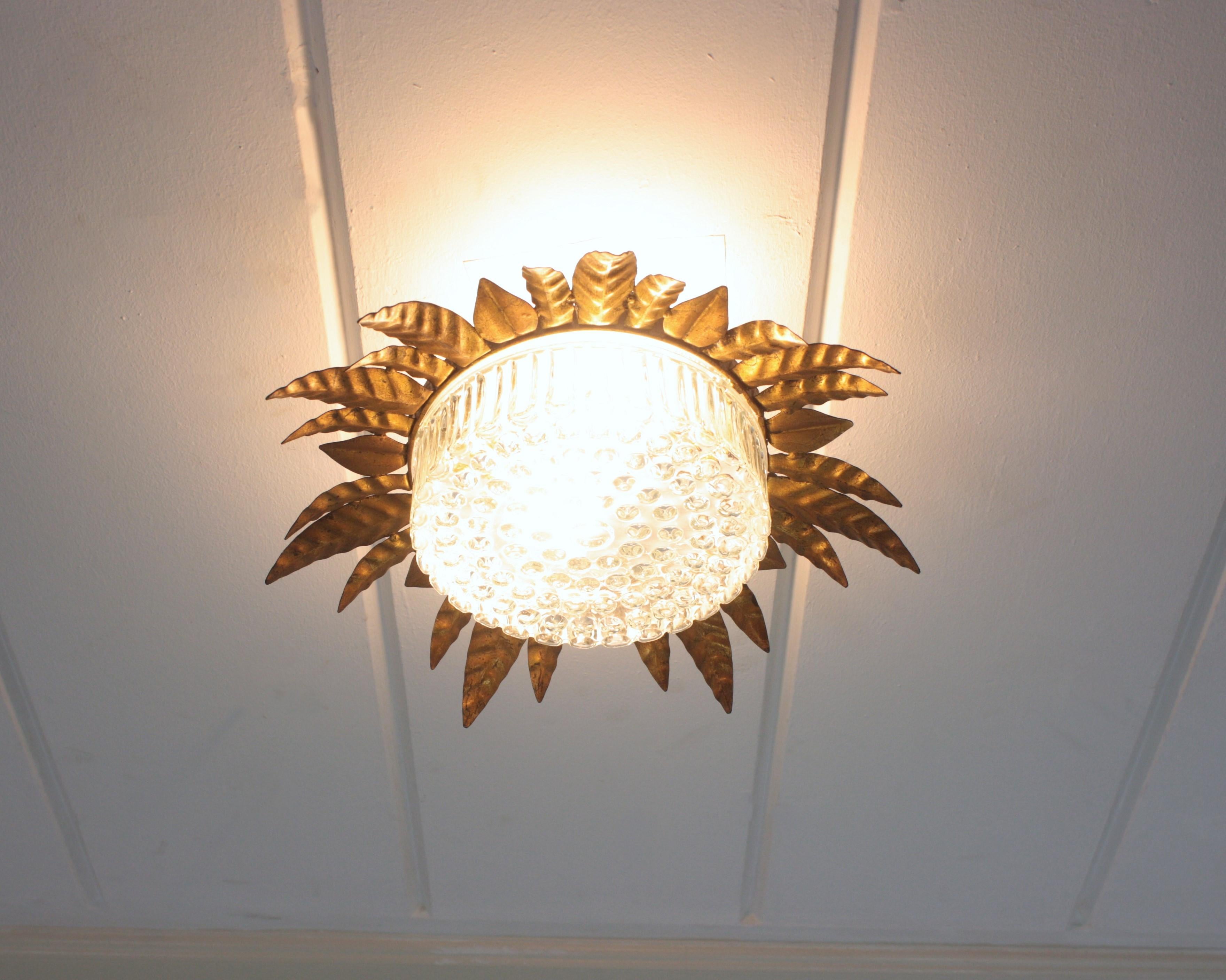 Large Sunburst Leafed Ceiling Light Fixture in Gilt Iron and Pressed Glass In Good Condition For Sale In Barcelona, ES