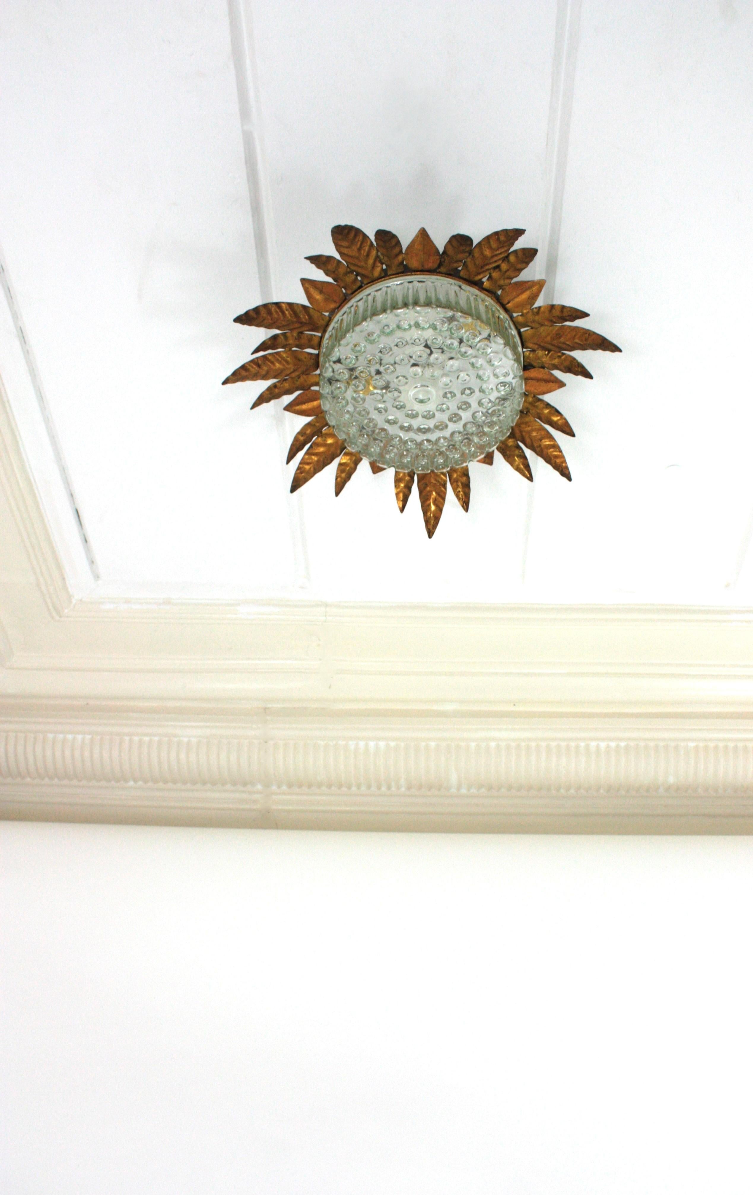 20th Century Large Sunburst Leafed Ceiling Light Fixture in Gilt Iron and Pressed Glass For Sale