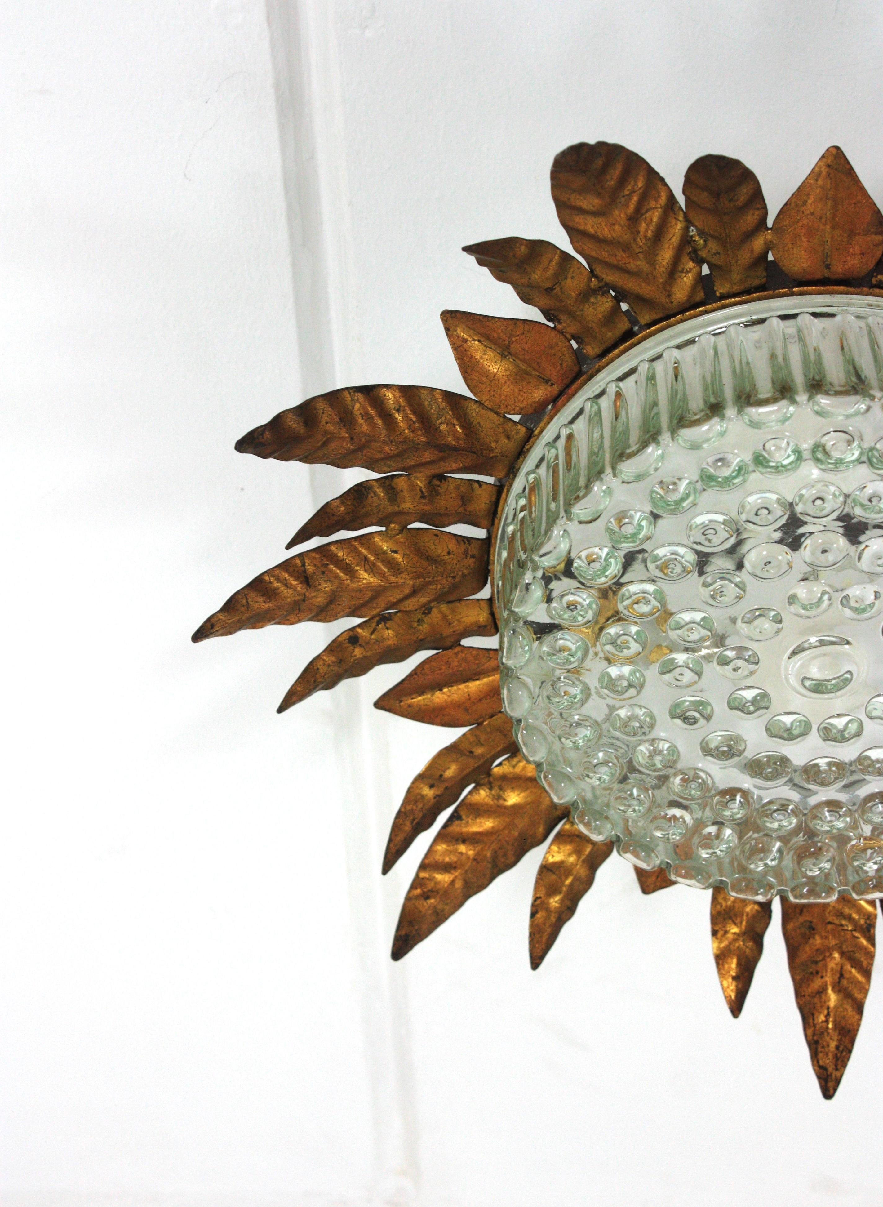 Large Sunburst Leafed Ceiling Light Fixture in Gilt Iron and Pressed Glass For Sale 1