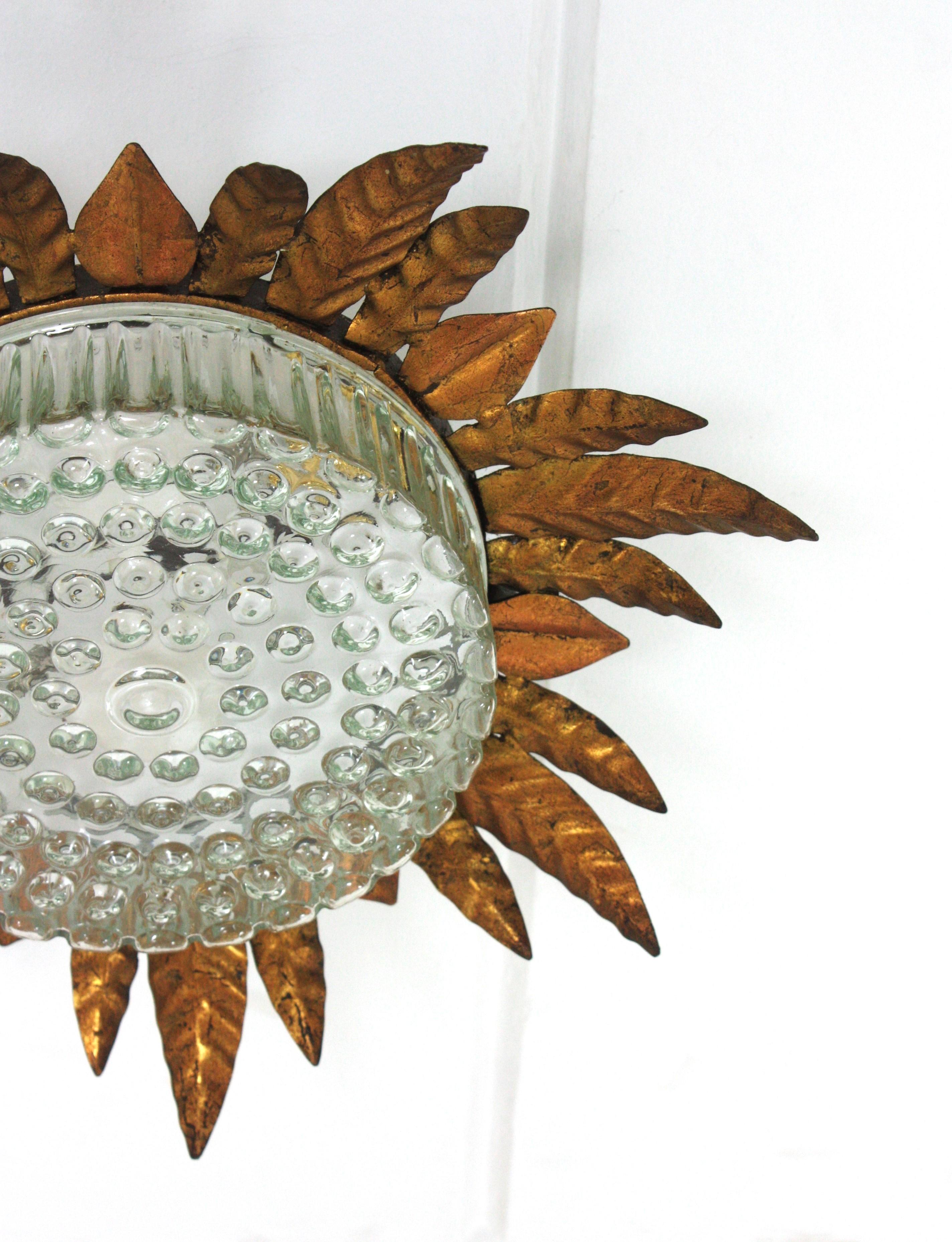 Large Sunburst Leafed Ceiling Light Fixture in Gilt Iron and Pressed Glass For Sale 2